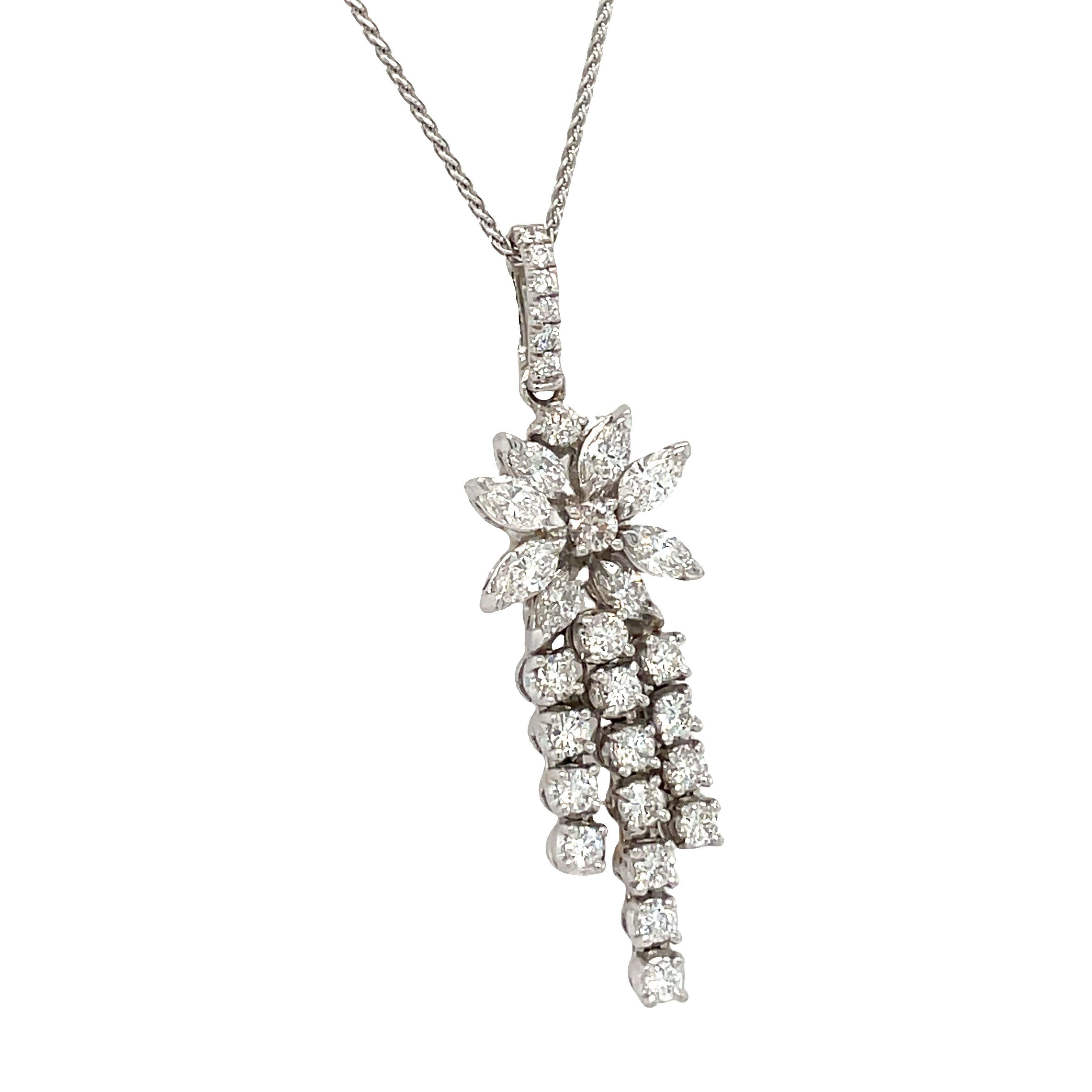 The breathtaking and whimsical nature of this necklace makes it a truly standout piece. This gorgeous piece features a beautiful flower design pendant crafted in 14k white gold. The pendant showcases a combination of round and marquise cut natural