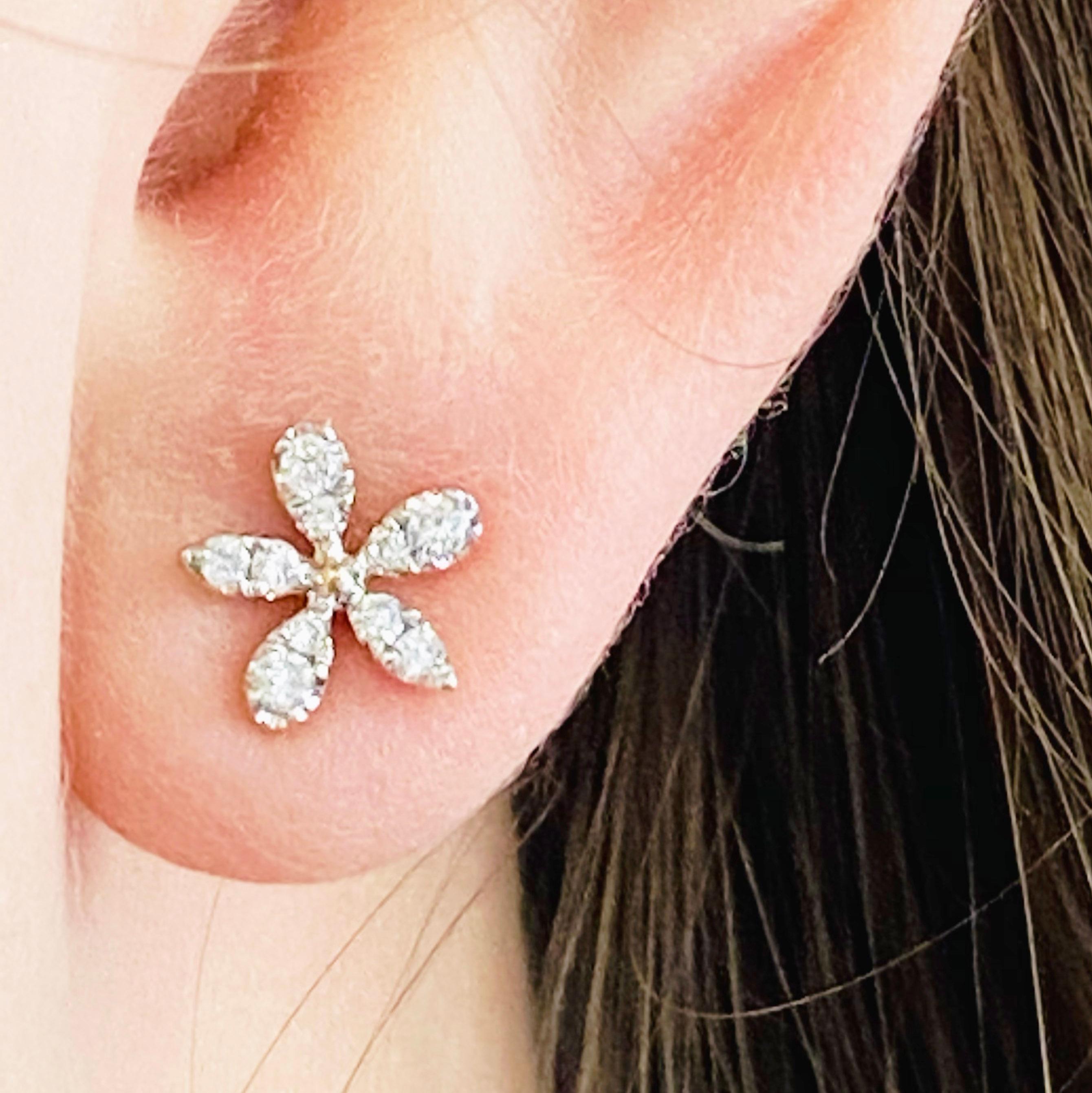 These stunning 14k yellow gold flower stud earrings dripping with diamonds provide a look that is both trendy and classic. These diamond earrings are a great staple to add to your collection, and can be worn with both casual and formal wear.  These