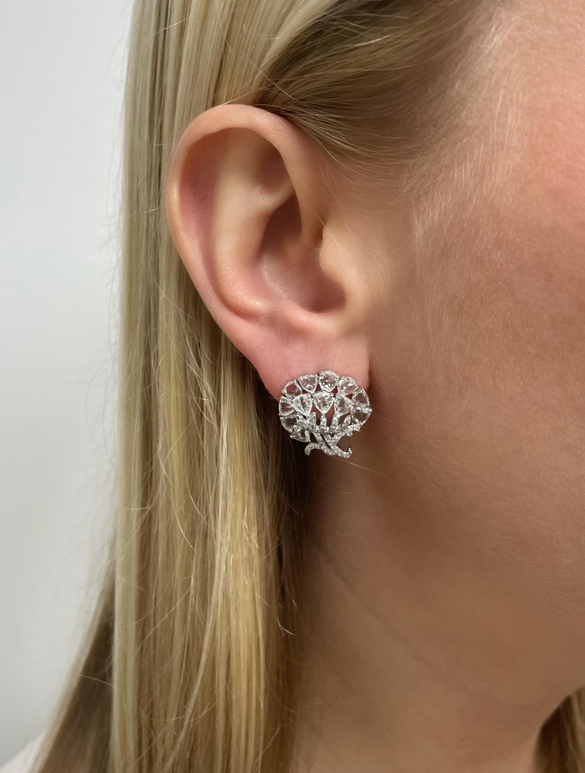 These light and airy flower earrings contain an array of pear shaped rose cut diamond petals and round brilliant cut diamond leaves and stem. Mounted in 18 karat white gold, these beautifully made earrings are perfect for any occasion!

Diamond