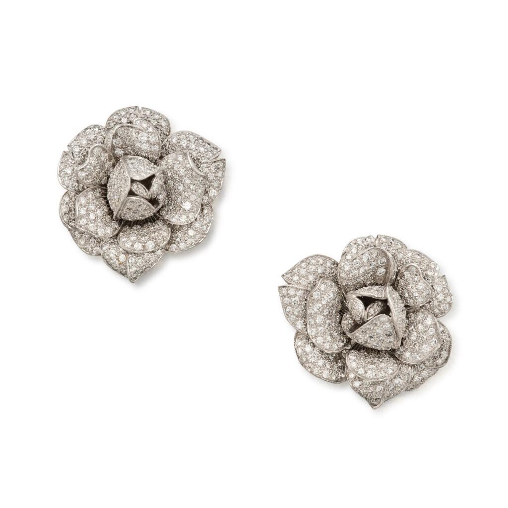 Diamond flower earrings in platinum and 18k white gold. The earrings crafted in a blooming flower head design.Encrusted with round brilliant cut diamonds with total weight of
approximately 13.30 carats Designed as flower heads, set with round