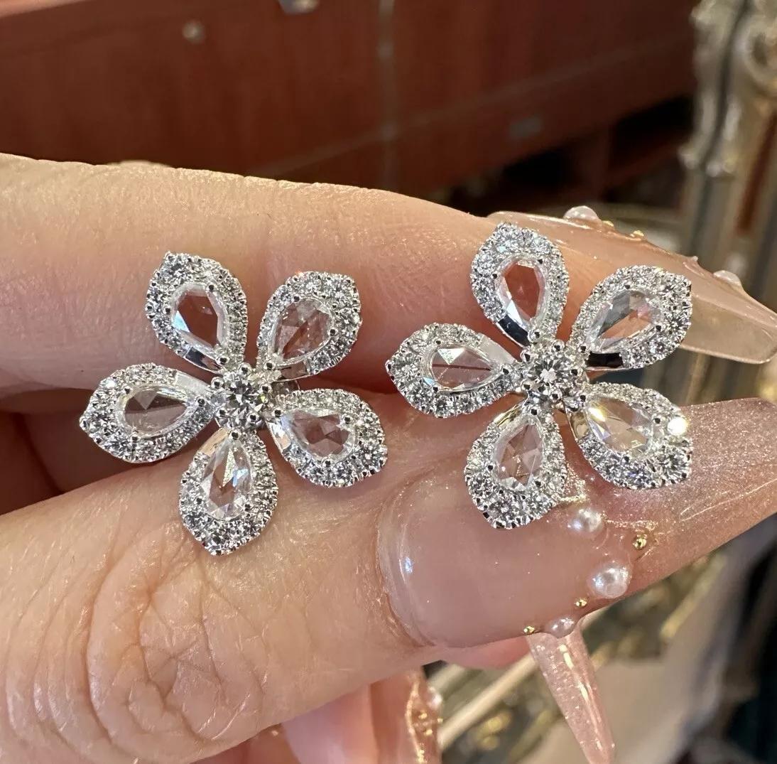 Diamond Flower Earrings with Rose Cuts 2.10 carat total weight in 18k White Gold

Diamond Flower Earrings feature Rose cut Pear shape Diamonds surrounded by Round Brilliant cuts with a single Round Diamond in the center, all set in 18k White Gold.