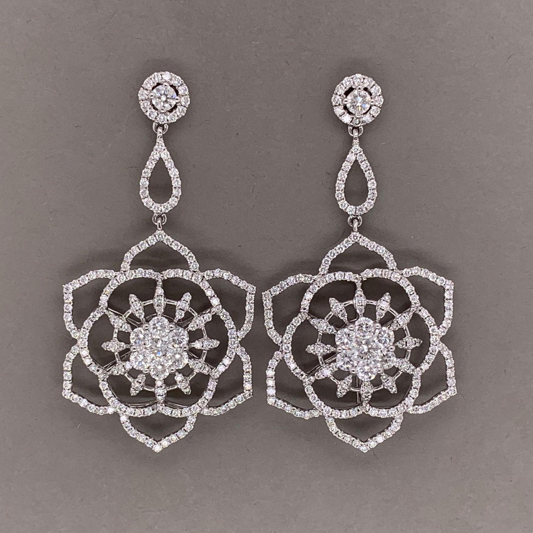 Dance in style with these long drop flower diamond earrings. They feature 3.42 carats of round brilliant cut diamonds which are set in 18k white gold. They depict blooming flowers which are the drops of these stylish earrings.


Length: 1.6 inches