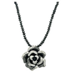 Collier à fleurs en or blanc avec diamants noirs taille briolette