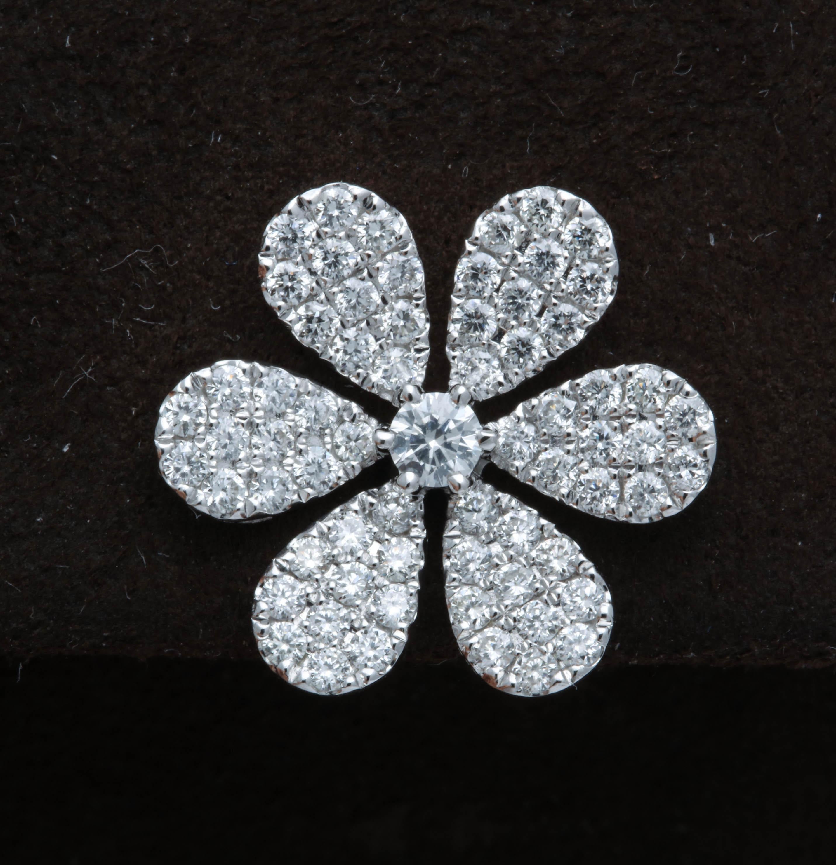 

A beautiful pair of diamond flower earrings.

1.32 carats of white round brilliant cut diamonds set in a classic and iconic flower design.

A comfortable and wearable pair of earrings, perfect for day into evening wear.

Approximately .85 inches