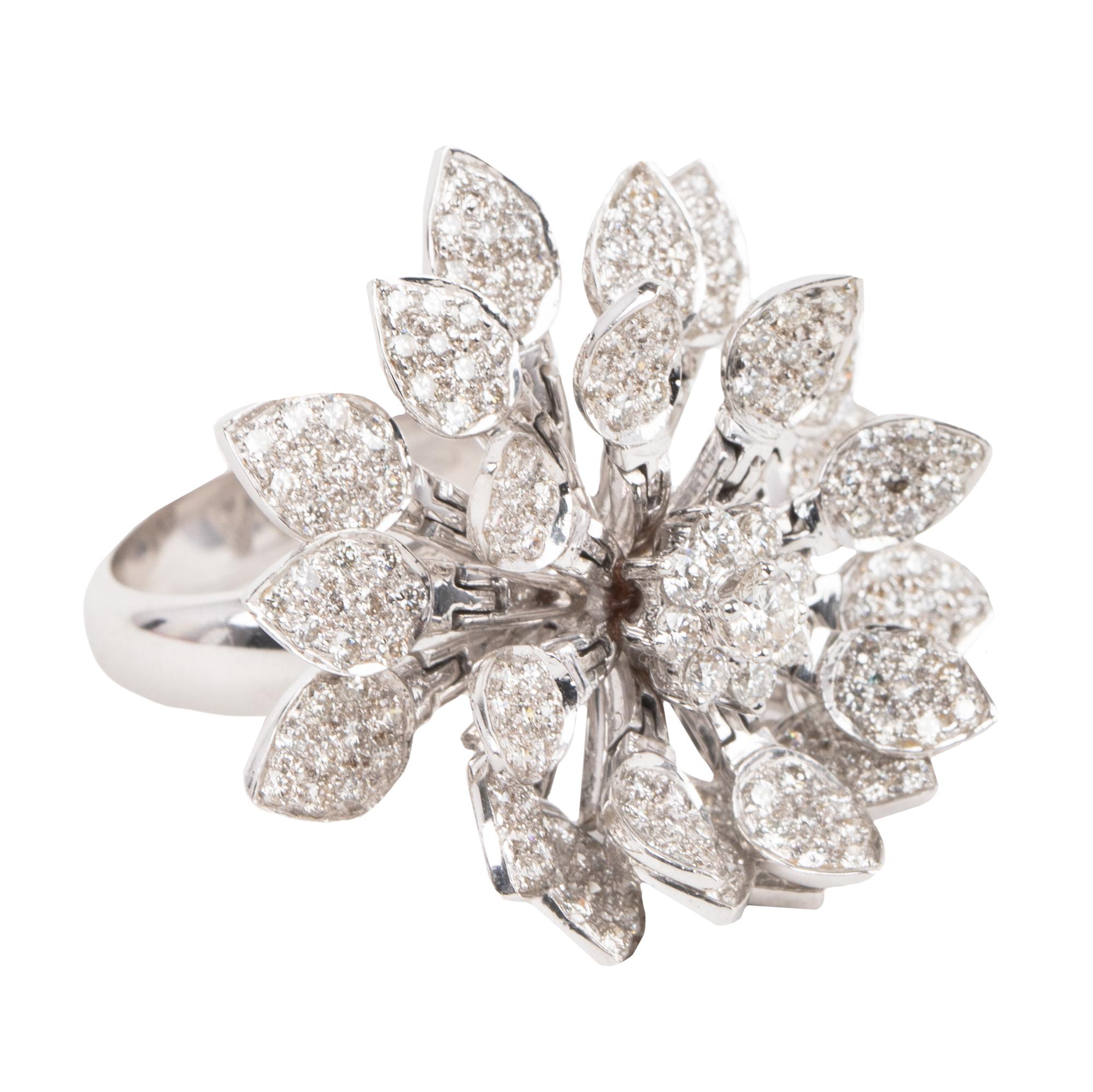 This artistic ring is a truly special work of art. The ring features diamond leaves that form a flower. With any hand movement, the leaves move to represent flowers blooming. Anyone who wears this ring is sure to turn heads as it is a statement