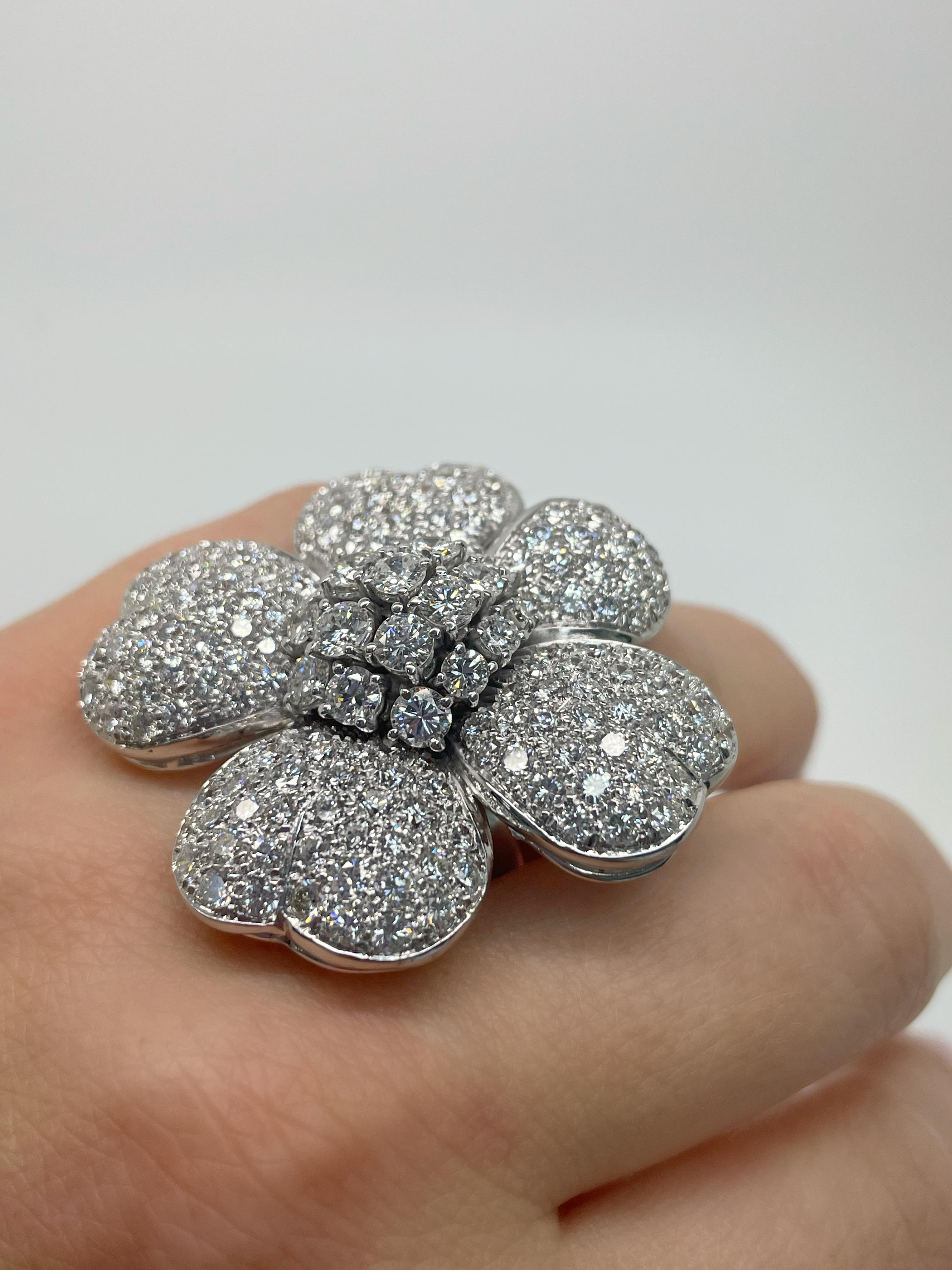 This fun flower ring contains top quality pave set round brilliant cut diamonds weighing approximately 13.00 carats total. Mounted in 18 karat white gold, this ring is the perfect whimsical touch for your collection. 

Stamp: 18K.
Ring Size: 6