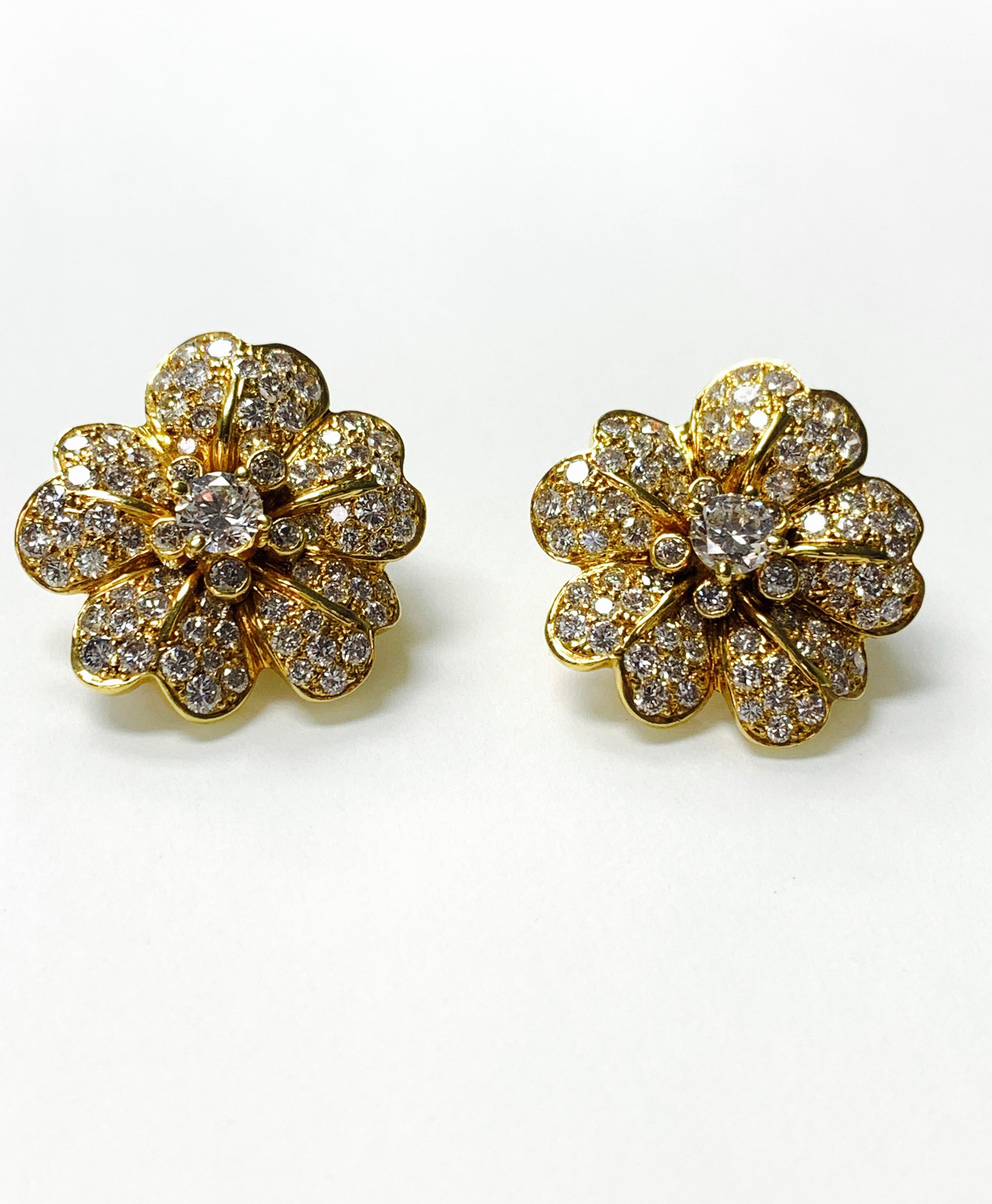 Diamond Flower Studs hand crafted in 18k  yellow gold. 
The details are as follows : 
Diamond weight : 0.95 carat + 5.50 carat ( HI color and SI clarity ) 
Metal : 18K Yellow gold 
Measurements : 1 inch by 1 inch. 
