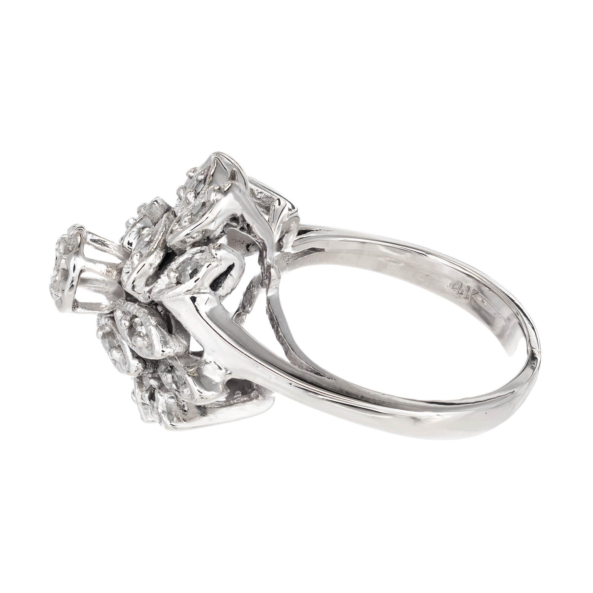 14k White gold diamond floral style high top cluster cocktail ring. Center stone is set up high with two rows of marquise shaped petals underneath. Each petal is set with a round diamond. 

1 round G-H VS diamond Approximate .10 carat total weight