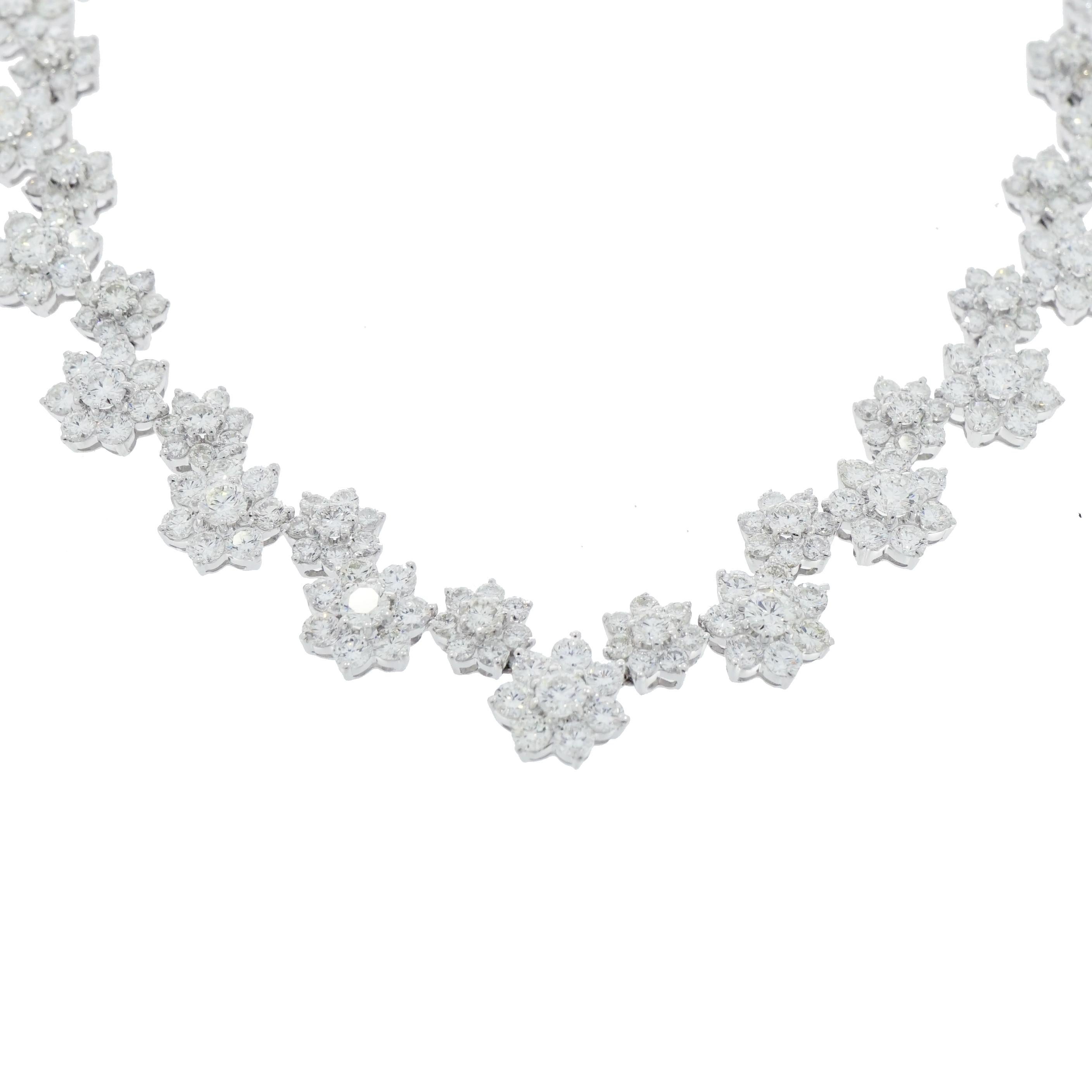 This is an exquisite Diamond Flower Necklace crafted in 18K White Gold with 400 round diamonds. G/H in color, SI1/SI2 clarity, weighing 46.20 carat total. 
A classic design of floral motive comprised of 15 larger flower clusters, each center