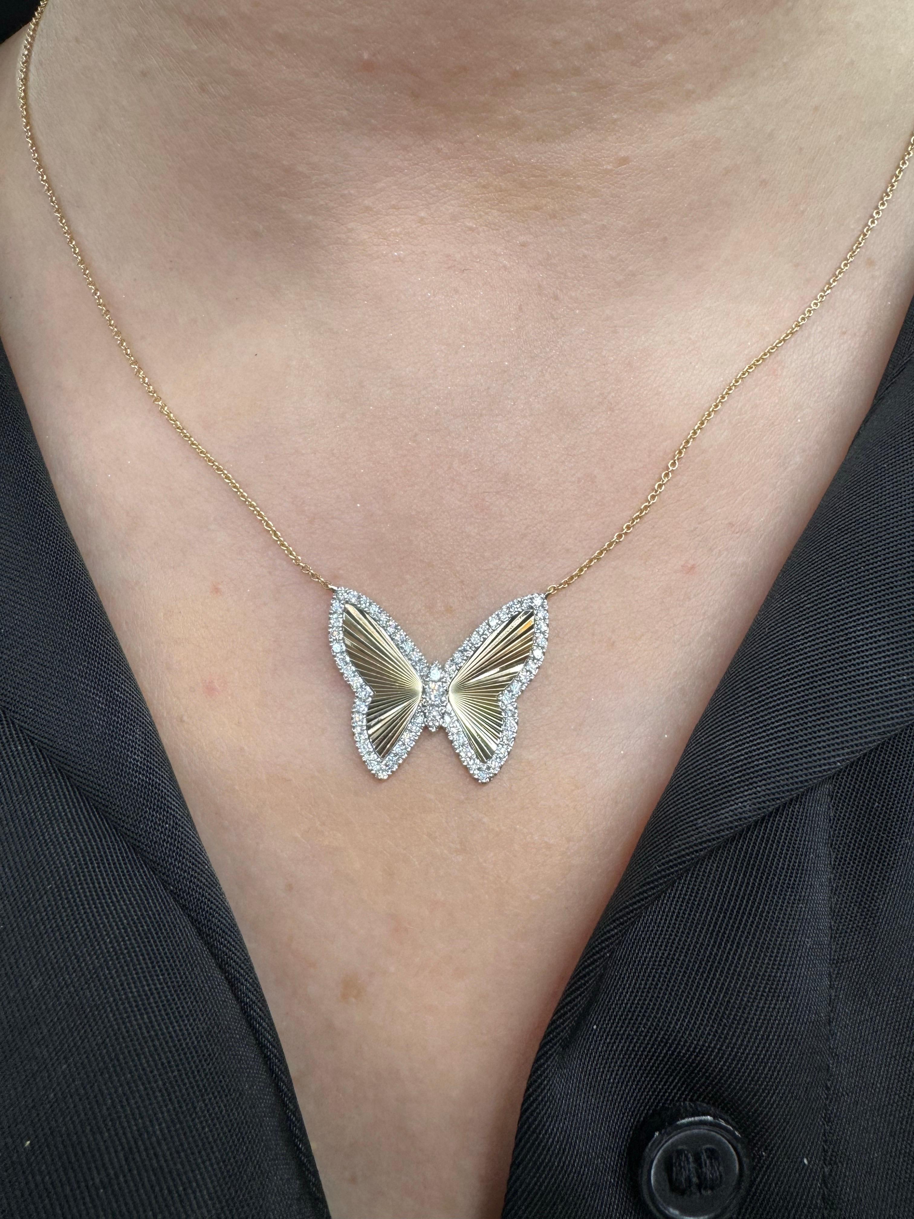 14 Karat yellow gold pendant necklace featuring a butterfly motif with a diamond outline and a fluted wing design, 0.56 carats.

Necklace can be 16