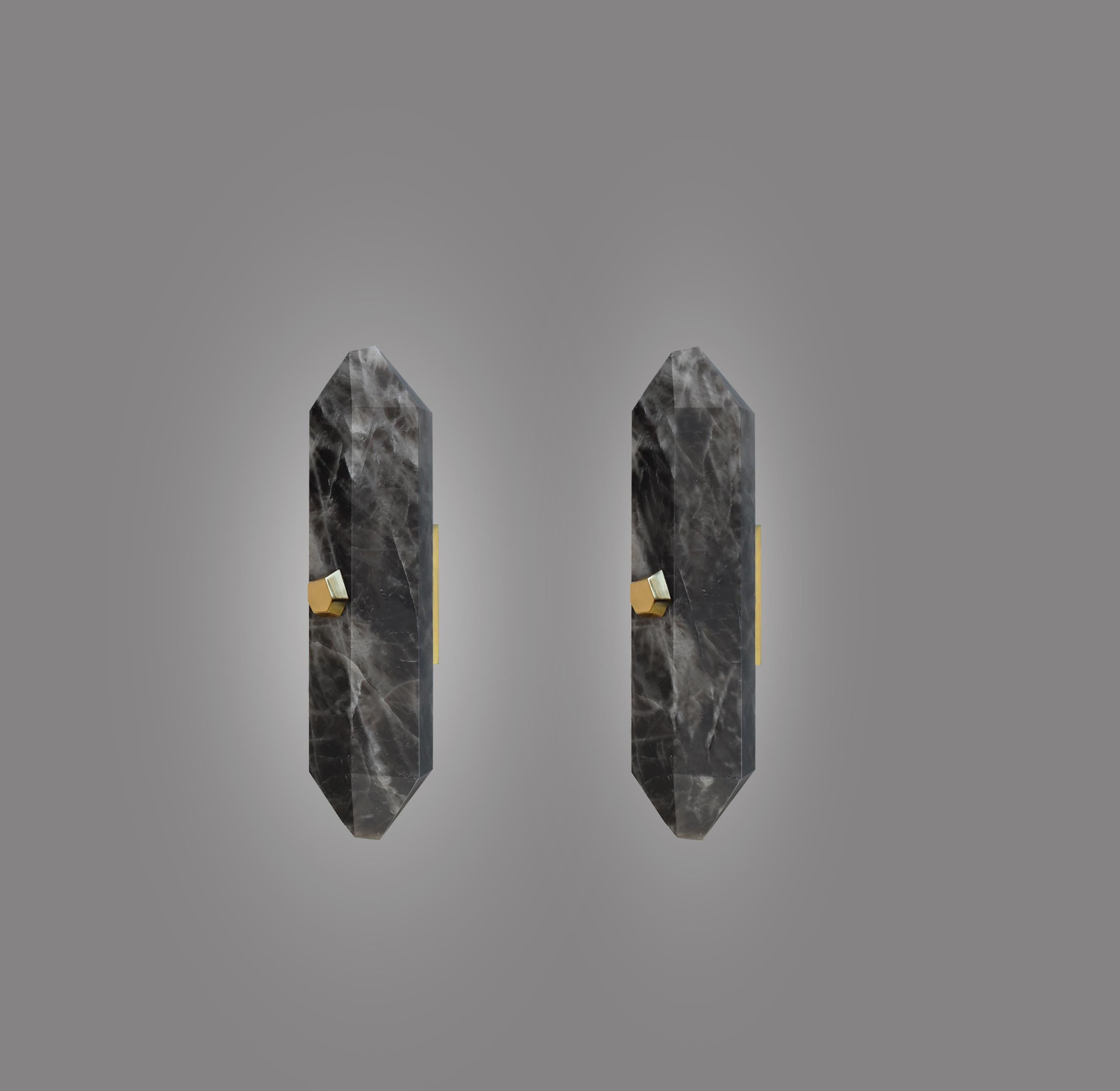 Pair of fine carved diamond form smoky rock crystal sconces with the polish brass mounts. Each wall sconce is installed with two sockets, 60watts max each socket, the total of 120 watt maximum. Created by Phoenix Gallery NYC.
Custom size, finish,