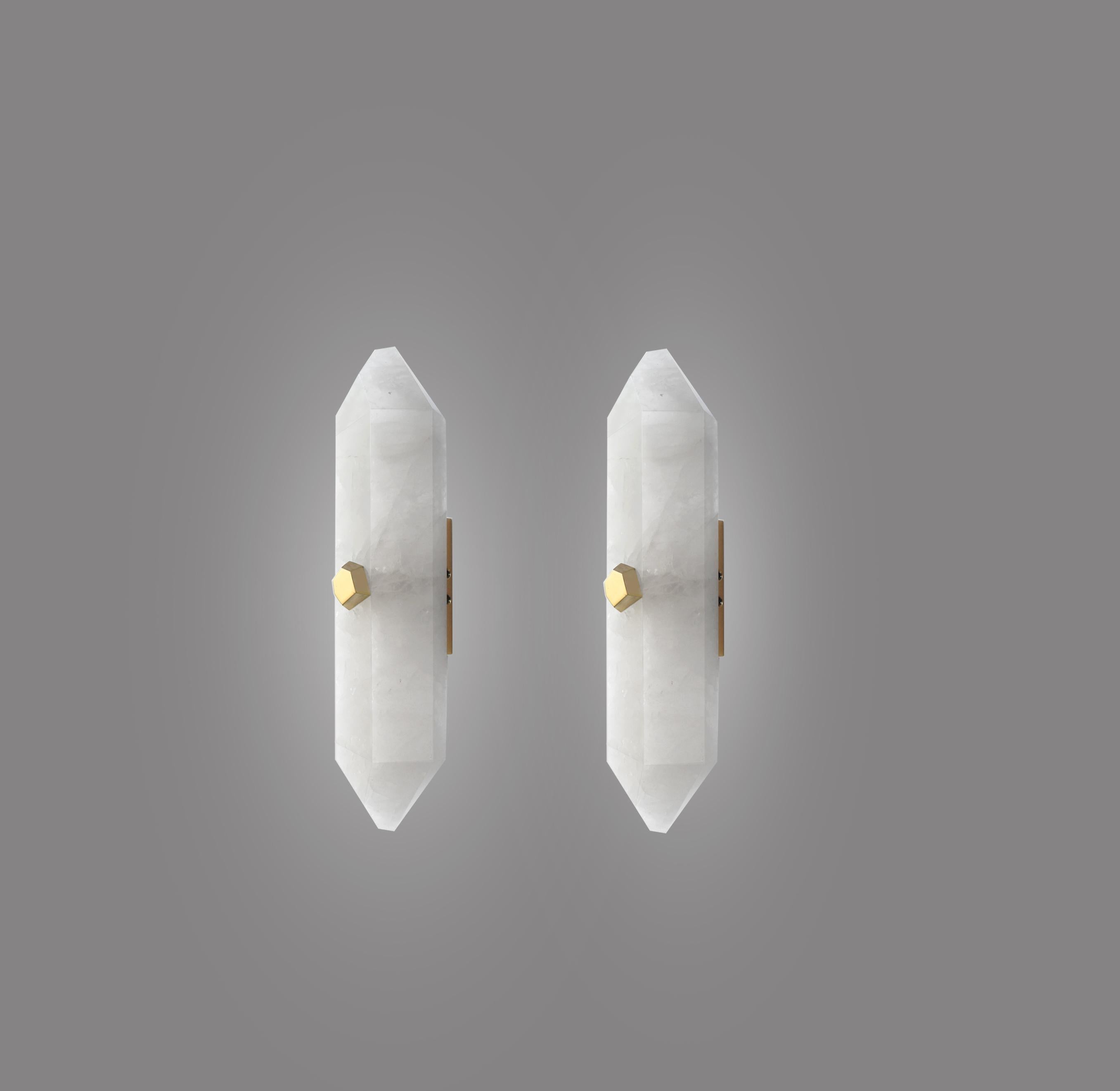 Pair of fine carved diamond form rock crystal sconces with the polish brass mounts. Each wall sconce is installed with two sockets, 60 watts max each socket, total 120-watt. Created by Phoenix Gallery NYC.
Custom size, finish, and quantity upon