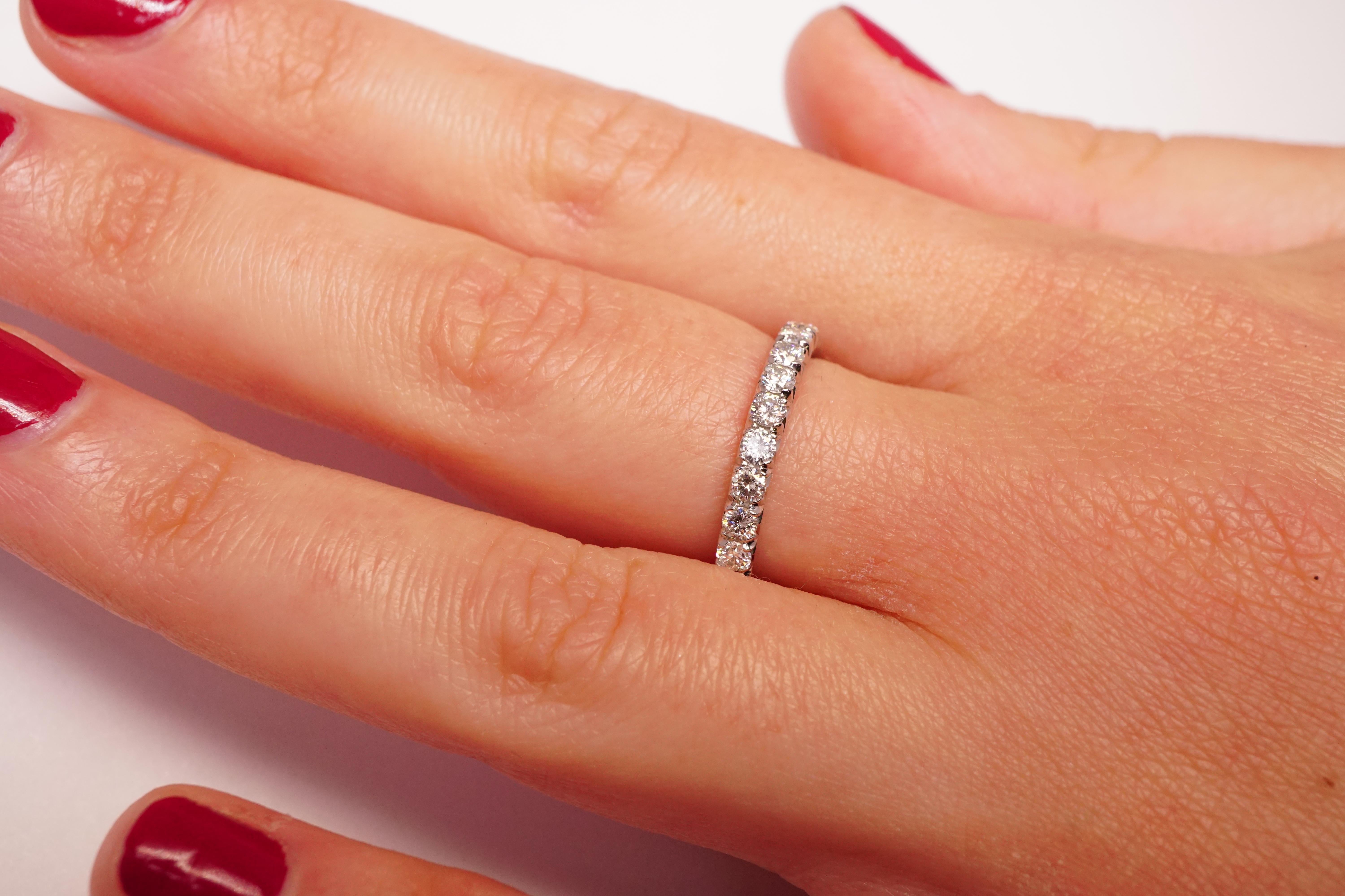 Diamond Eternity Wedding Band set in Platinum. 25 French cut micro-pave set brilliant round diamonds are F-G VS2. Carat weight = 1.5ct. Total ring weight 4 grams. Ring size 5.25. Can be sized upon request. This ring is customizable, price may vary