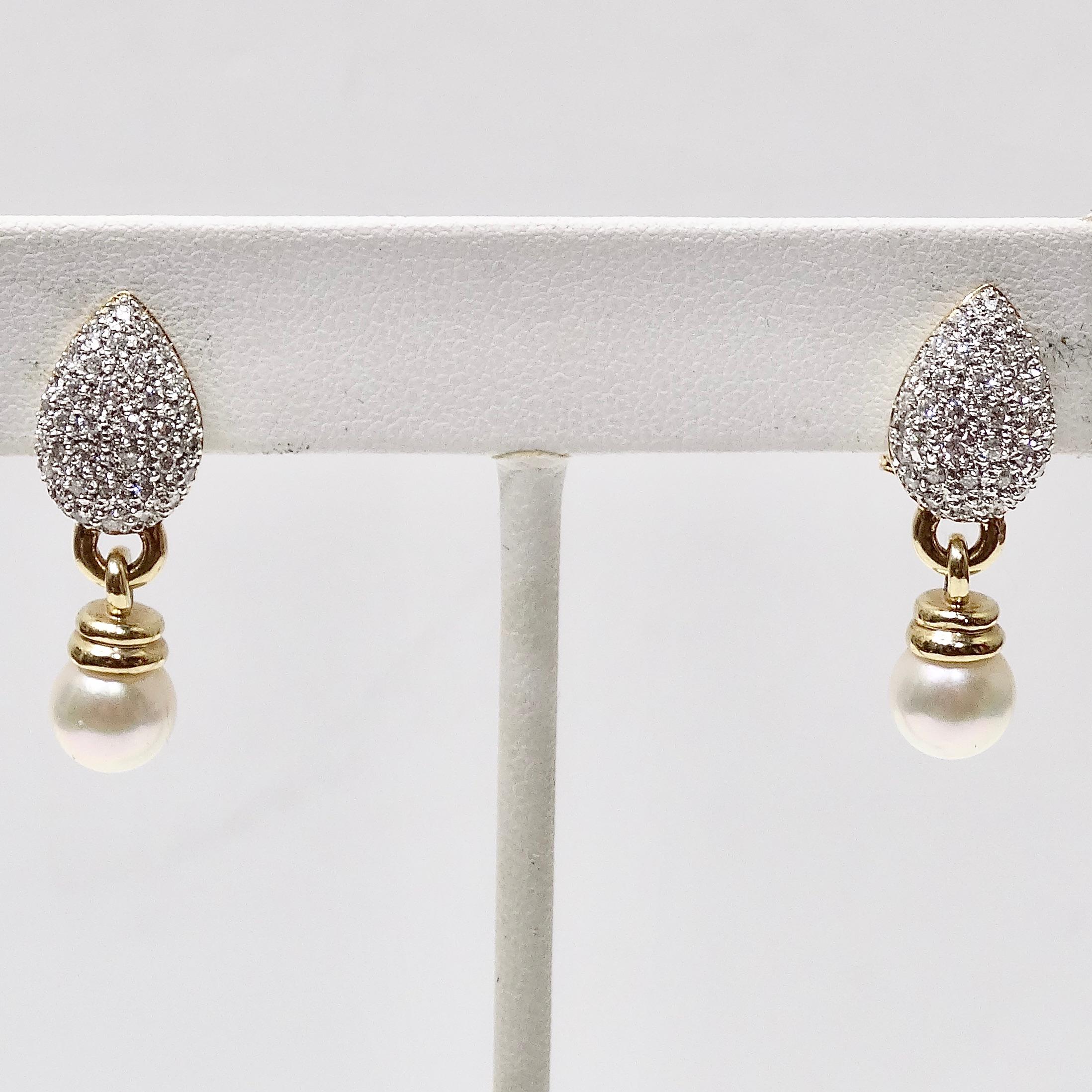 These vintage diamond and pearl earrings are so classic and breath taking! Gorgeous 14K gold drop style earrings circa 1980s feature an arrangement of small clustered diamonds accompanied by a beautiful freshwater pearl dangling as the finishing