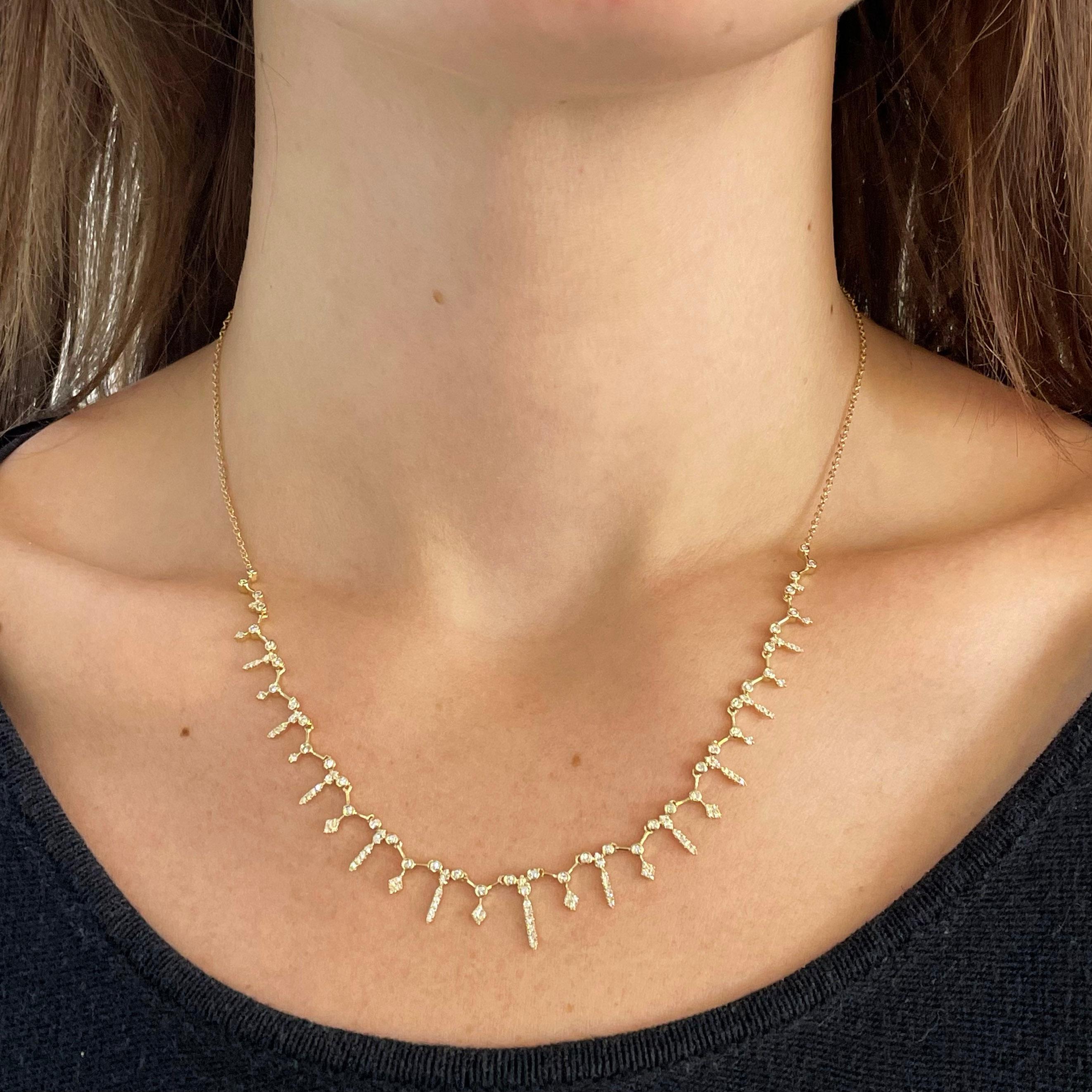 Whether you need a new addition to your set of layered necklaces, or a piece that can speak for its self, this is the piece for you. The stunning diamond fringe necklace is beautify crafted in 14 karat yellow gold with .60 carats of diamonds to give