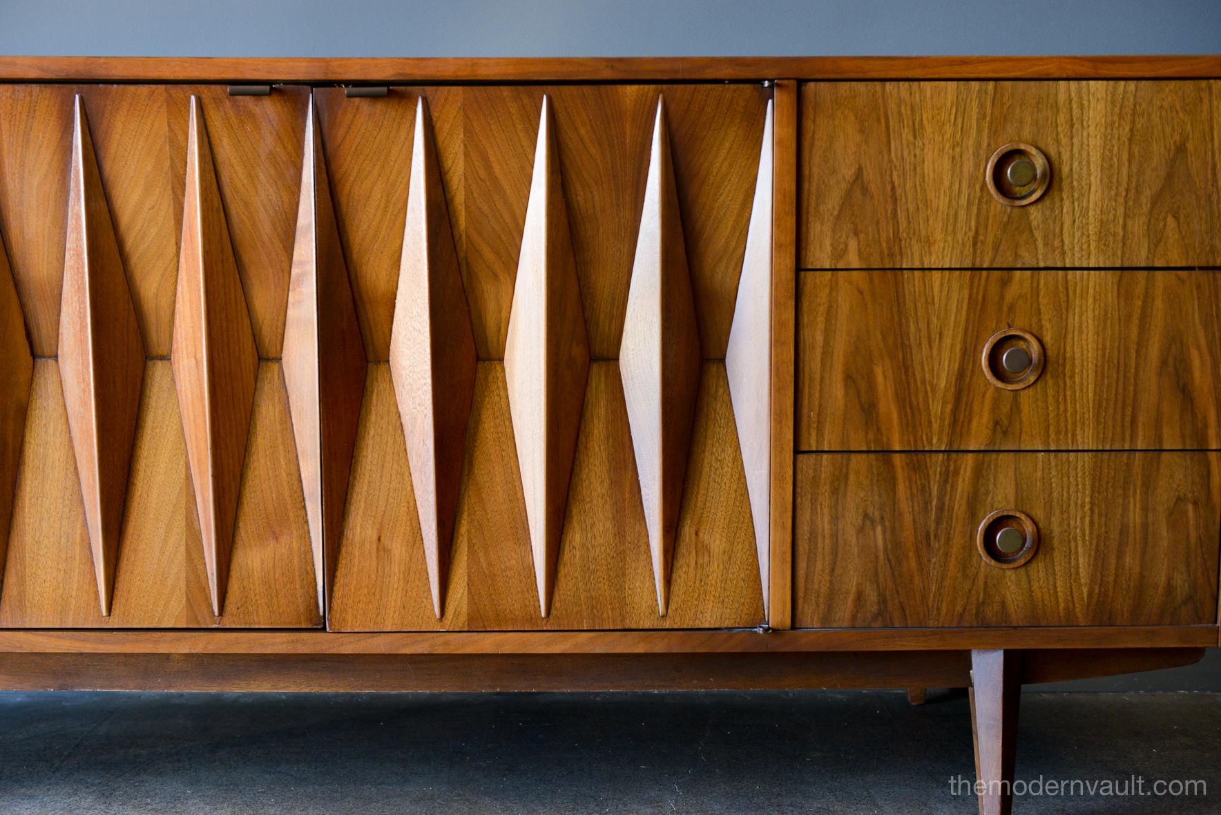 Diamond front sculpted walnut credenza by Albert Parvin, circa 1960. Beautifully sculpted solid walnut detailing with double doors that open to three inner drawers. Six smaller drawers on the outside. Beautiful original condition, hardly any wear as