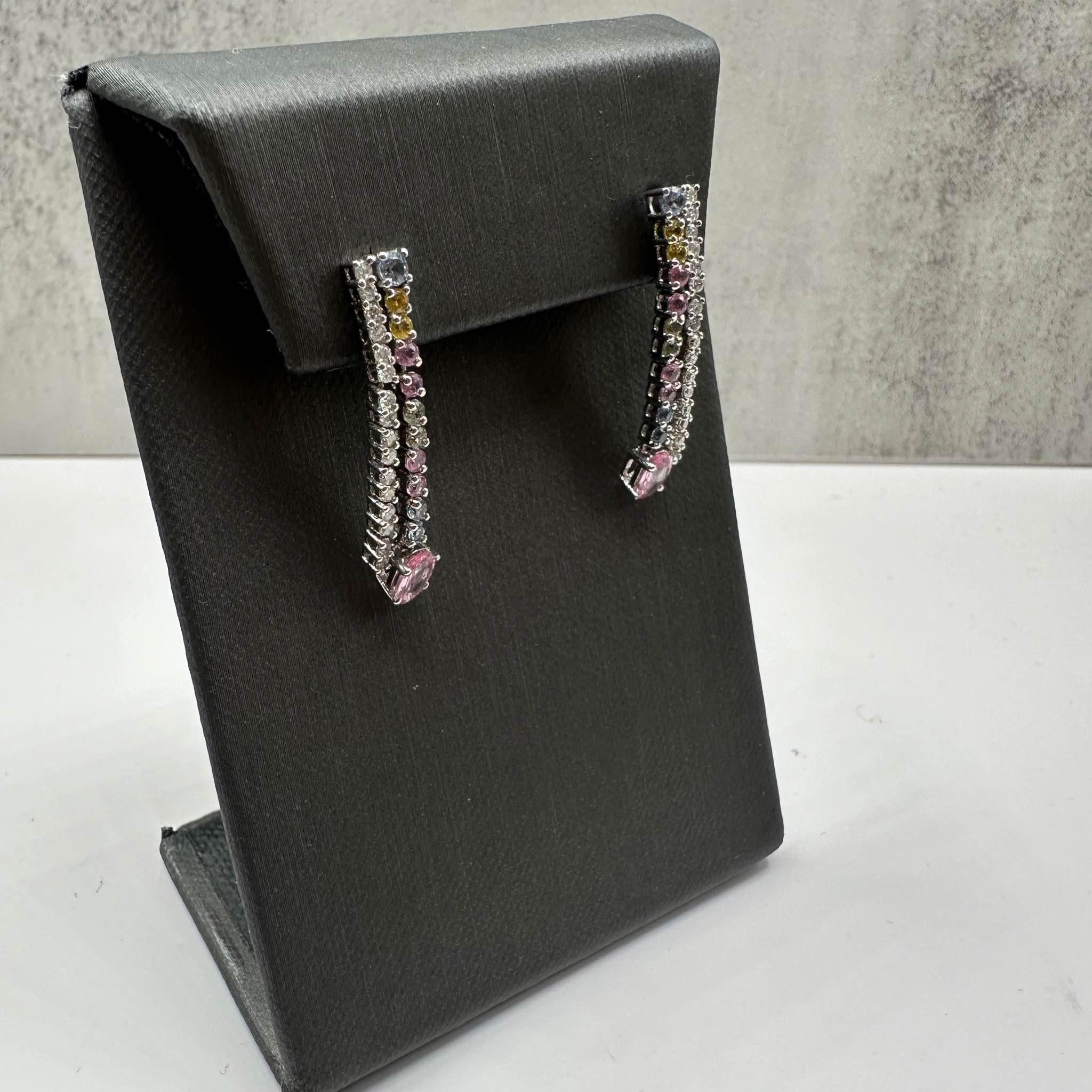 These stunning Diamond and Gemstone Drop Earrings in sterling silver feature approximately 0.16ctw of natural GH I1 round diamonds, complemented by approximately 0.65ctw of natural mixed gemstones for a colorful and sparkling contrast. Weighing 4.6
