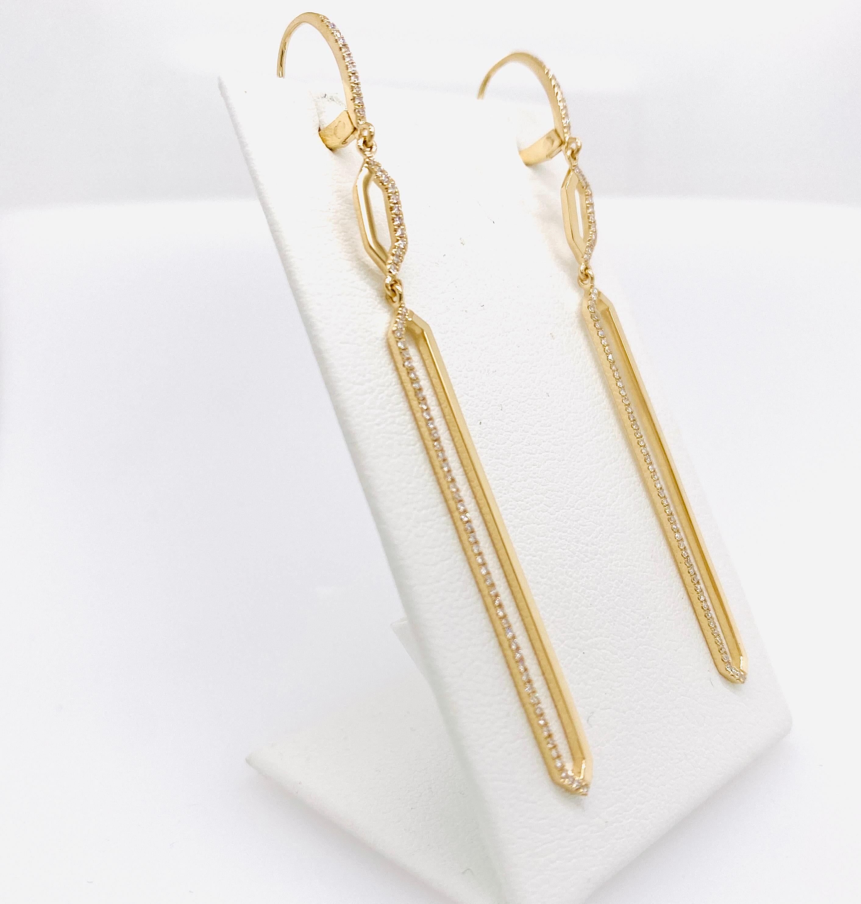 Gracefully dancing dangles hang from your ears in these beautifully contrasting geometric long link earrings. The narrow line of the earring makes it easy to wear and accent your face and neck. The hinged lever back earring top has diamonds down the