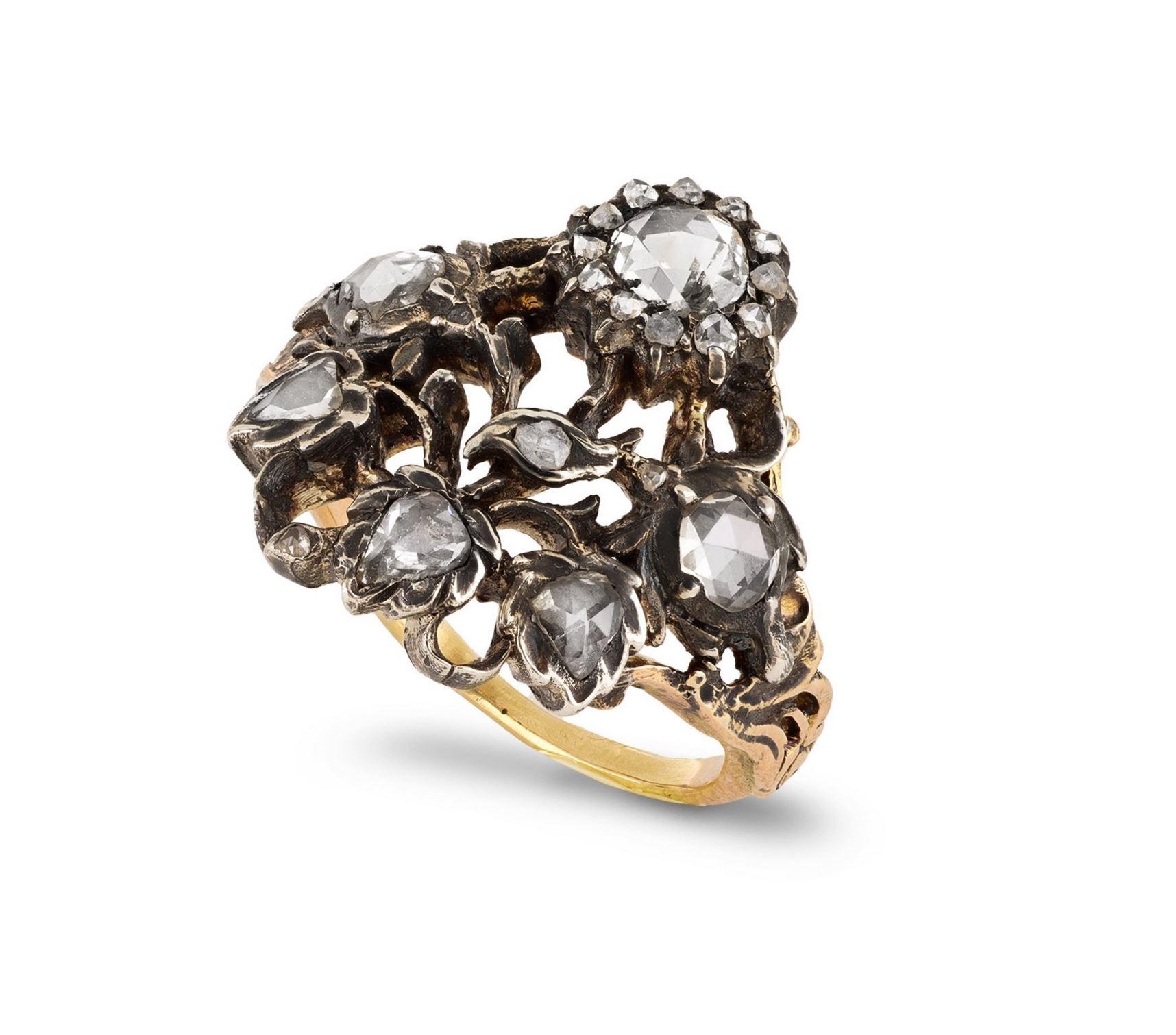 Diamond Giardinetti ring. Set with a round rose cut diamond in a closed back grain setting with an approximate weight of 0.30 carats, further set with fifteen round rose cut diamonds in closed back cut-down settings with a combined weight of 0.15