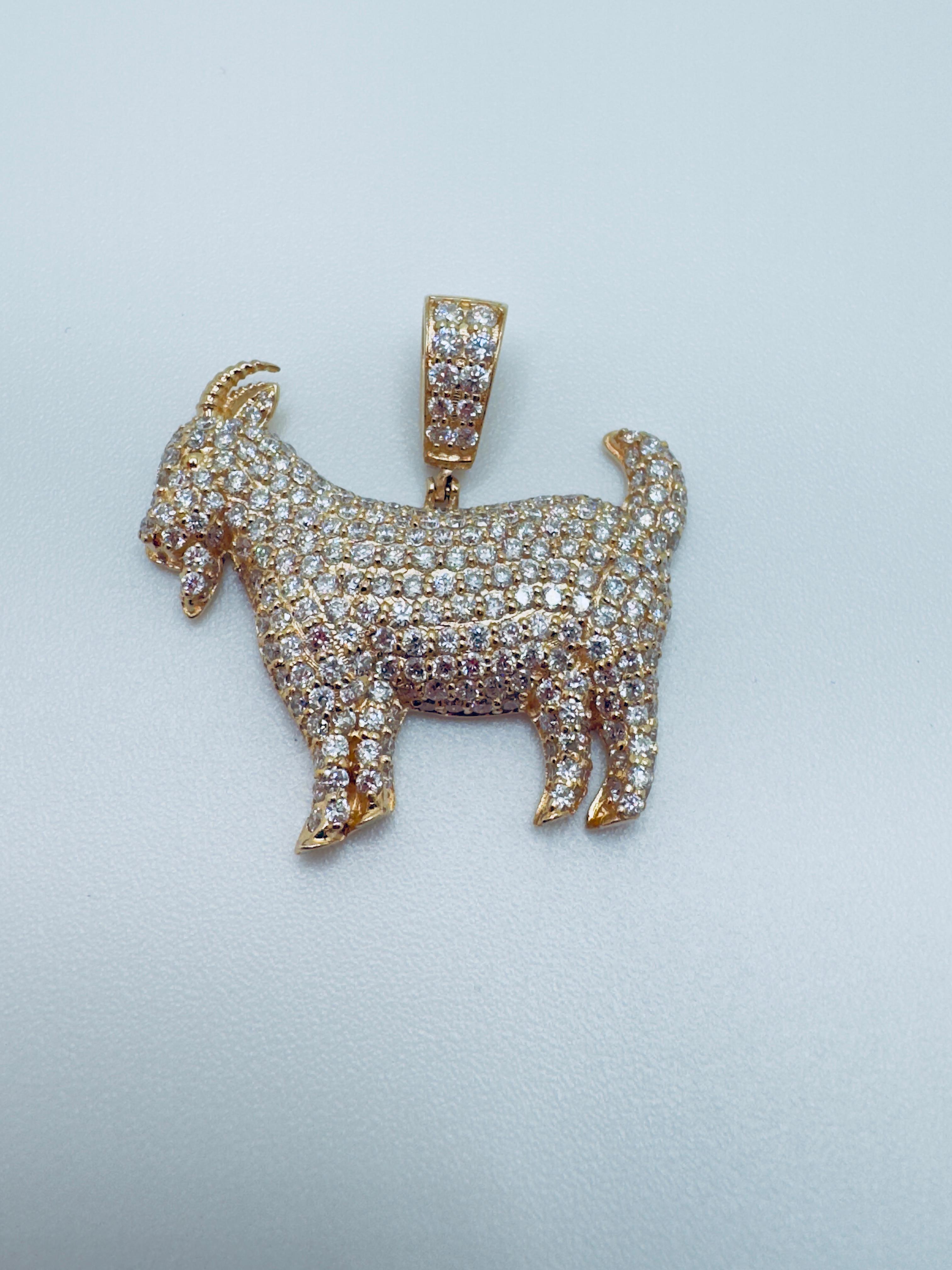 This striking pendant is masterfully crafted in 14K gold and showcases a bold “GOAT��” design, symbolizing greatness and excellence. The piece is fully adorned with brilliant-cut diamonds, pavé set across the surface for maximum sparkle and shine. The