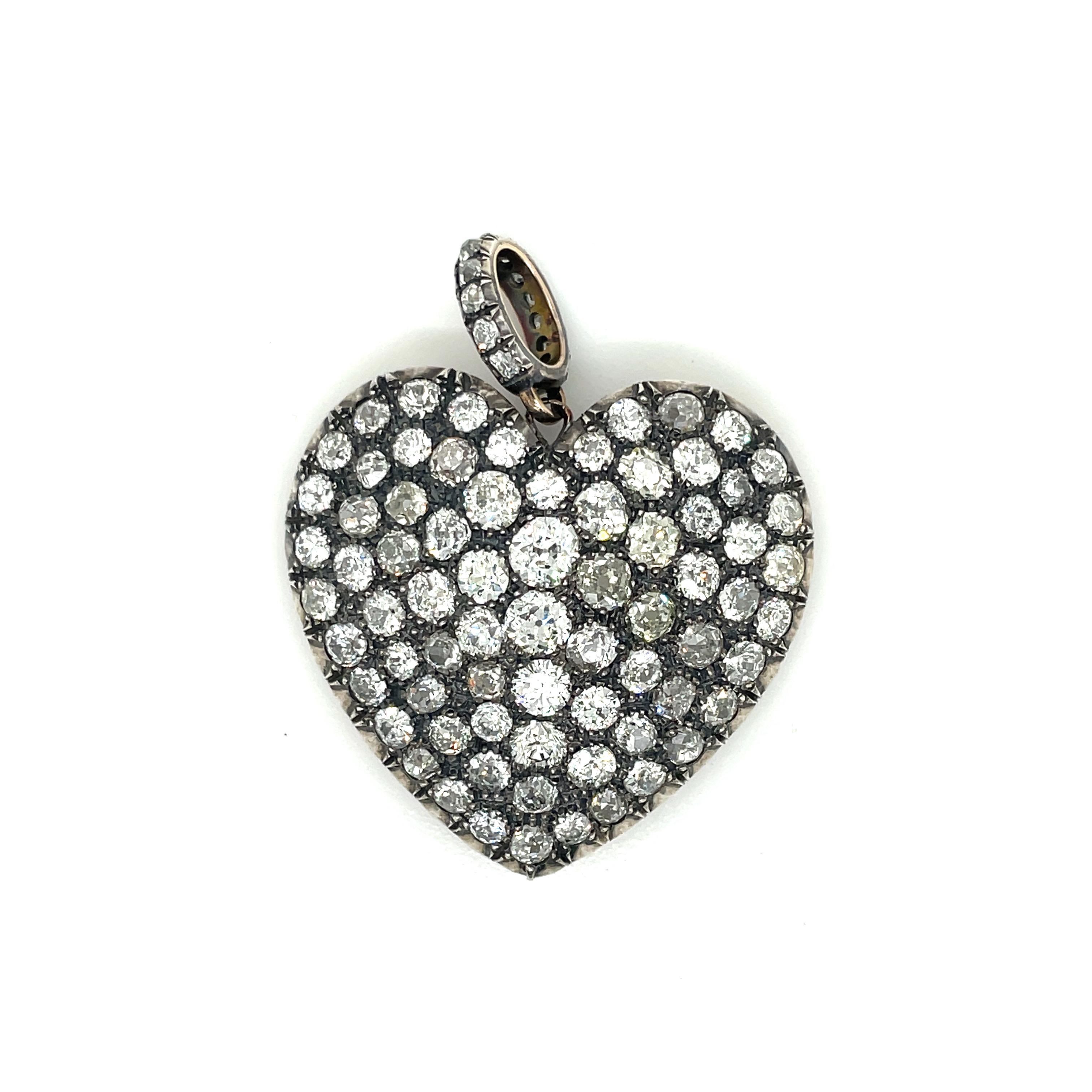 Delightful heart-shaped pendant handmade in 18 kt gold and silver in the late 1970s in Italy. Set with approximately 80 round old mine cut diamonds (VS clarity - H-I-J color) for a total of approximately 15.00 ct.

CONDITION: Pre-owned -