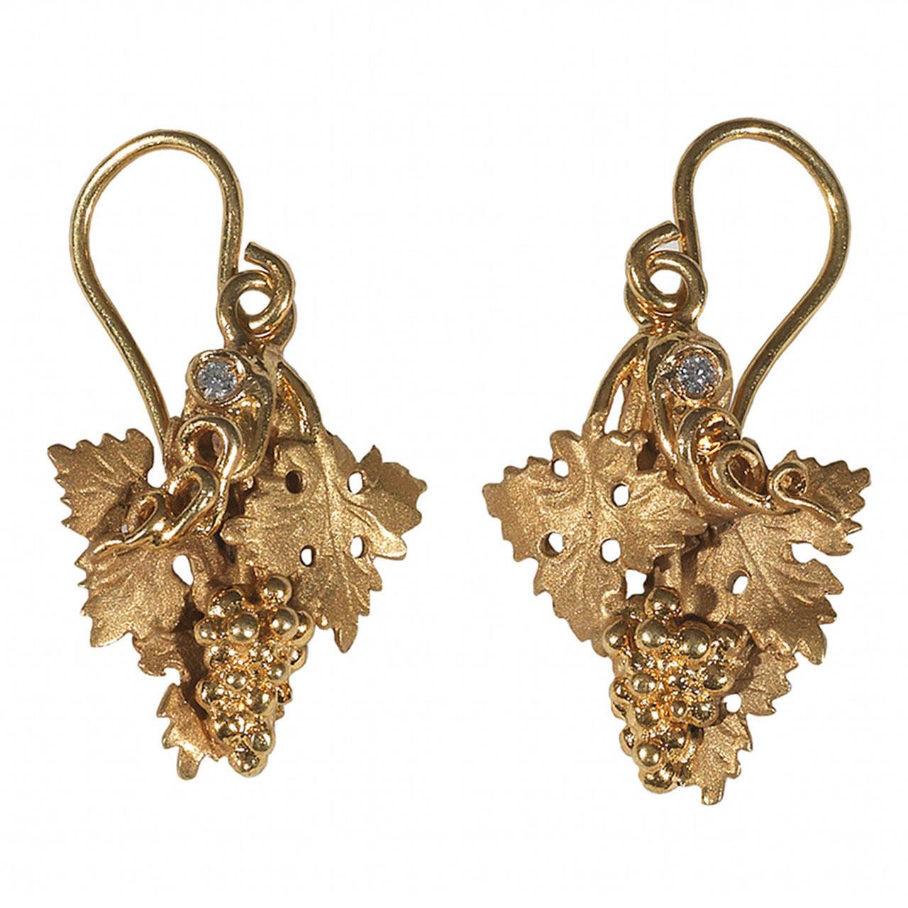 

The earrings of leaves and a bunch of grapes design. 
Mounted in 18Kt Gold

Full length: 30 mm