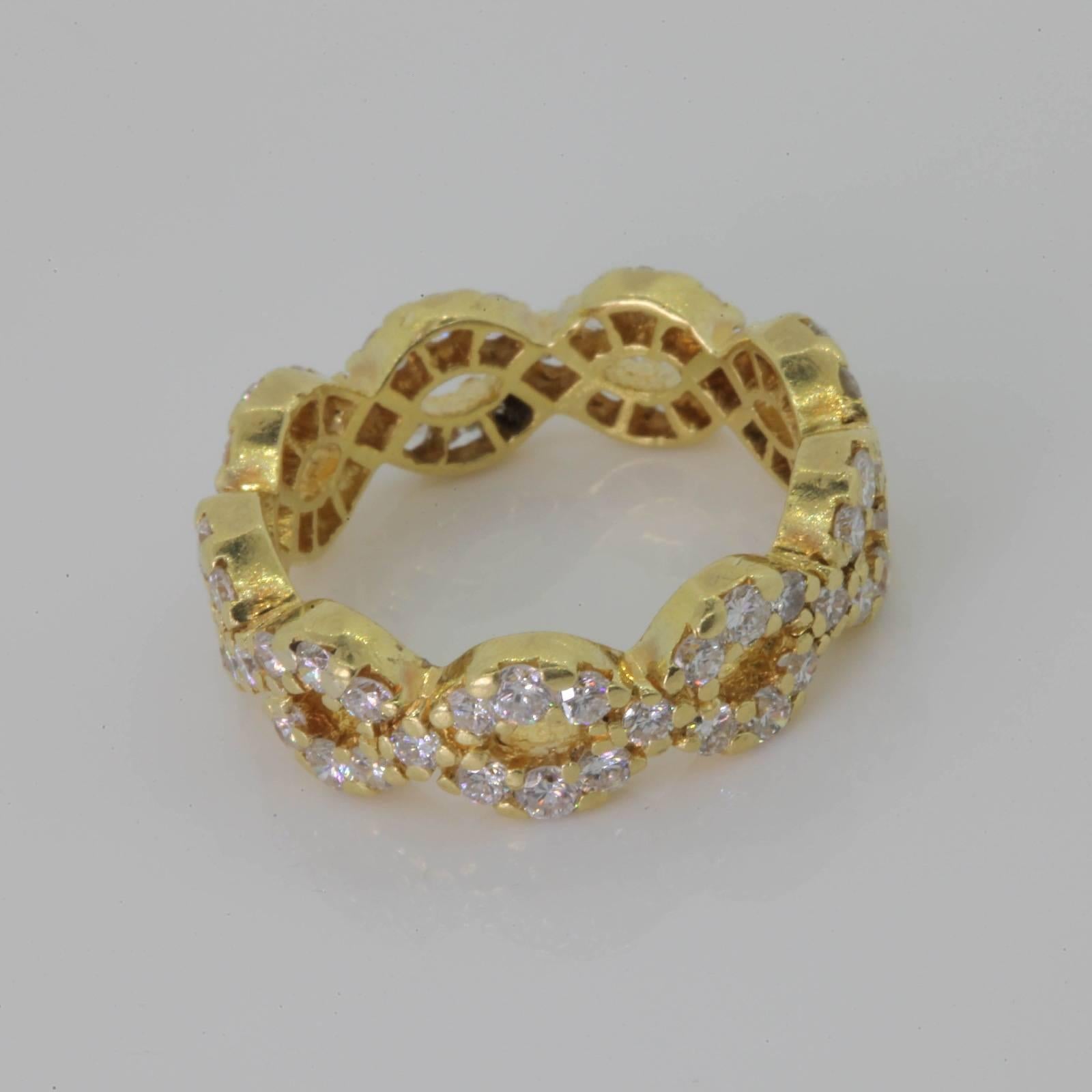 This stylish 18KT yellow gold band of two intertwining rows is set with 2.00 carats of shimmering Round Brilliant Cut Diamonds, all of H color - VS clarity.   
