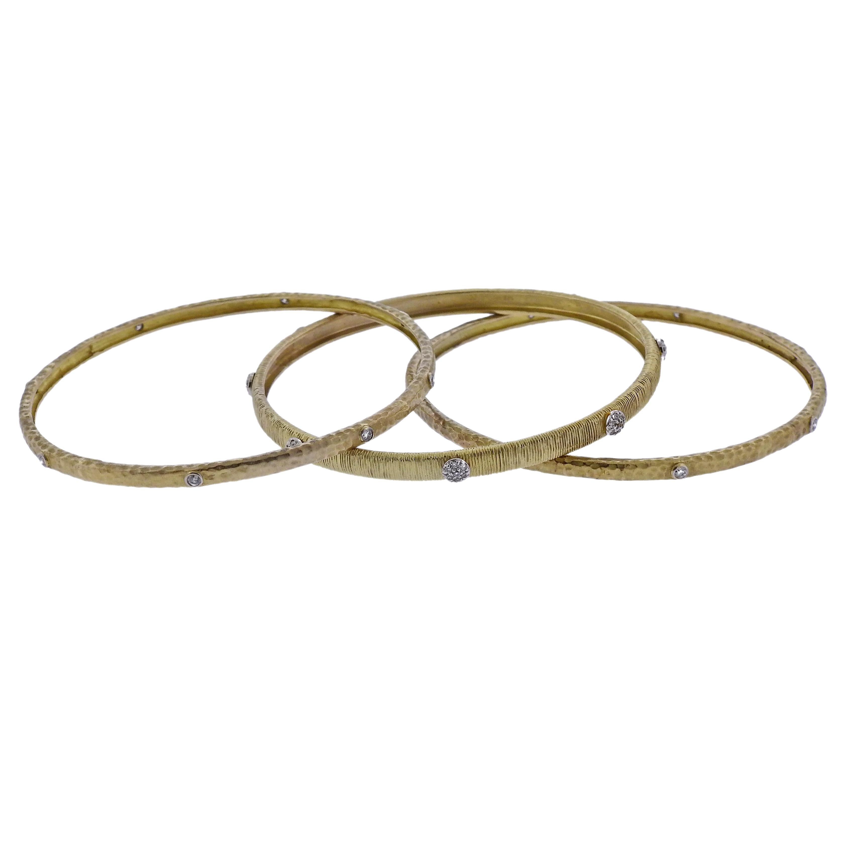 Set of three 14k gold bangle bracelets, all set with a total of approx. 0.56ctw in diamonds. Bracelets will fit approx. 7