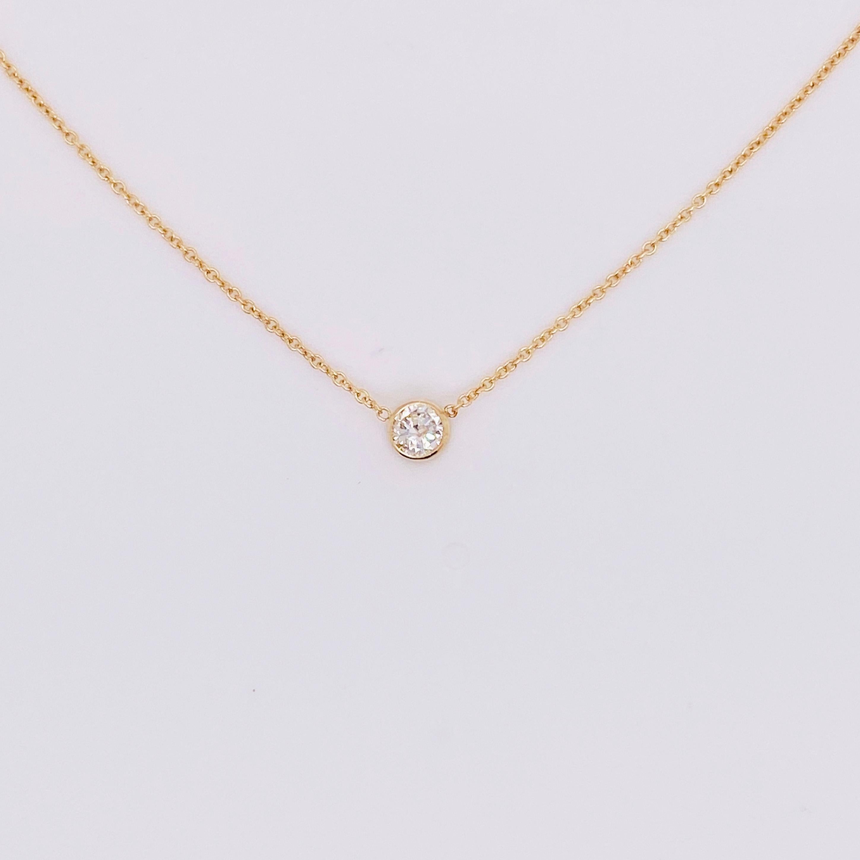 This diamond necklace has a beautiful 0.09 carat diamond set in a stunning 14 karat yellow gold bezel and rope chain. This necklace is a classic design that is perfect on any neck. The elegant rope chain is the perfect design for a bezel set