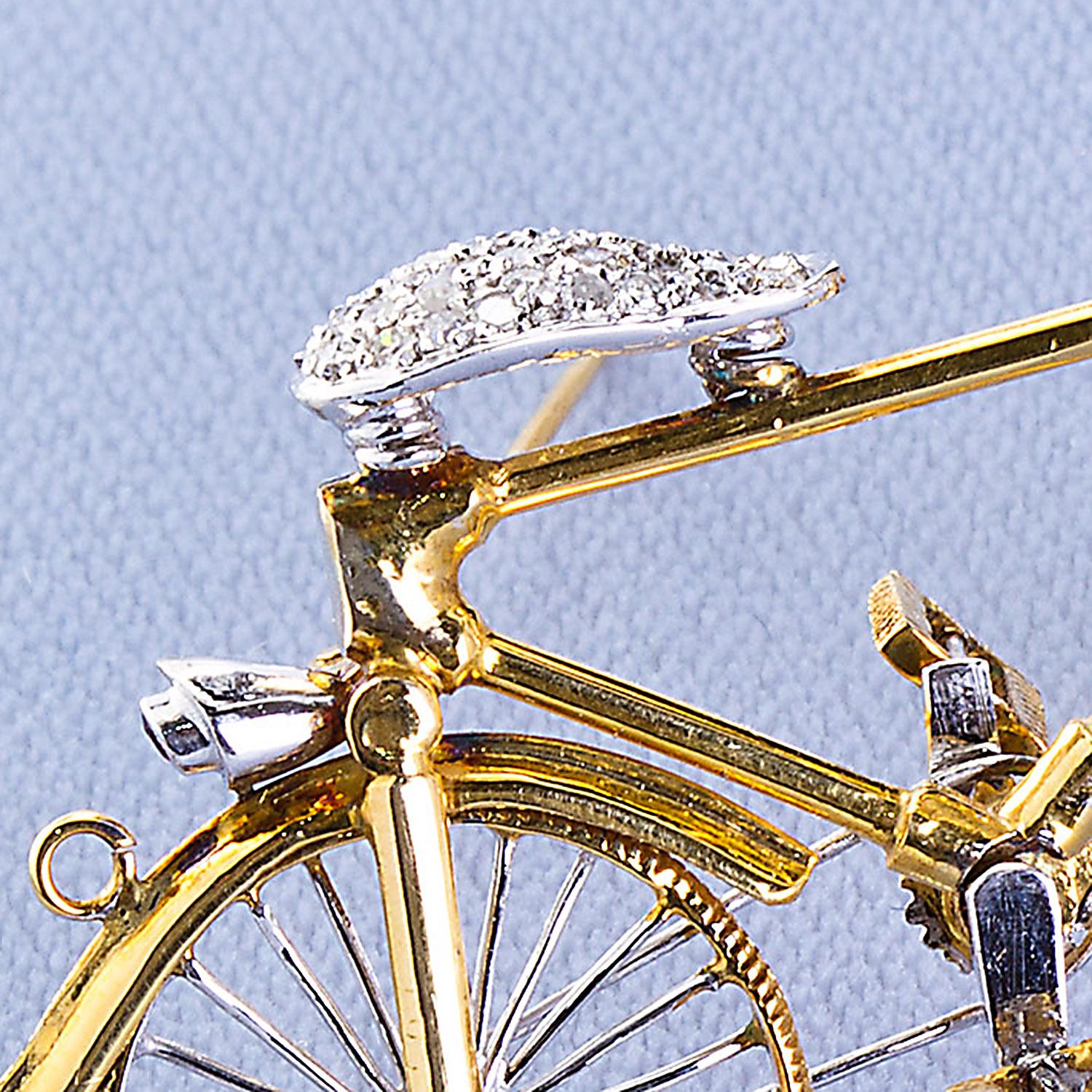 An 18k gold and diamond accents bicycle brooch with working wheels and pedals. Approx.  2 inches long. Diamonds 0.65 ctw

No. TMWJ-6213