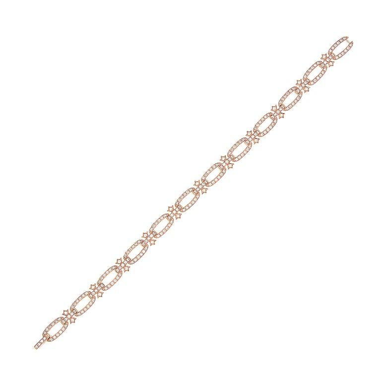 This delicately sweet bracelet set in 14K rose gold features 2.00 carats of round cut VS quality diamonds pave set in oval shaped hoops interlocked by diamond studded bars and bows. The hidden lock has a smooth and clean finish. 

Fits wrists up to