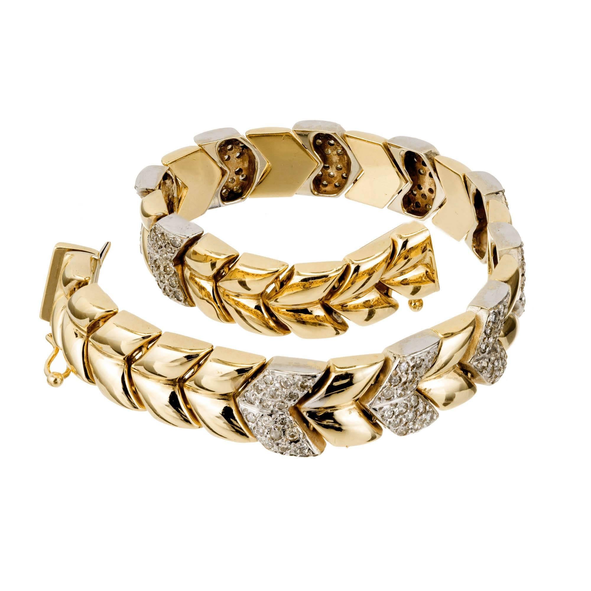 Chevron link solid 14k yellow gold 3/8 inch wide hinged bracelet with white pave set diamond sections set with full cut diamonds. Circa 1960-1970. Built in catch and side lock safety.

180 full cut diamonds approx. total weight 2.50cts, H,