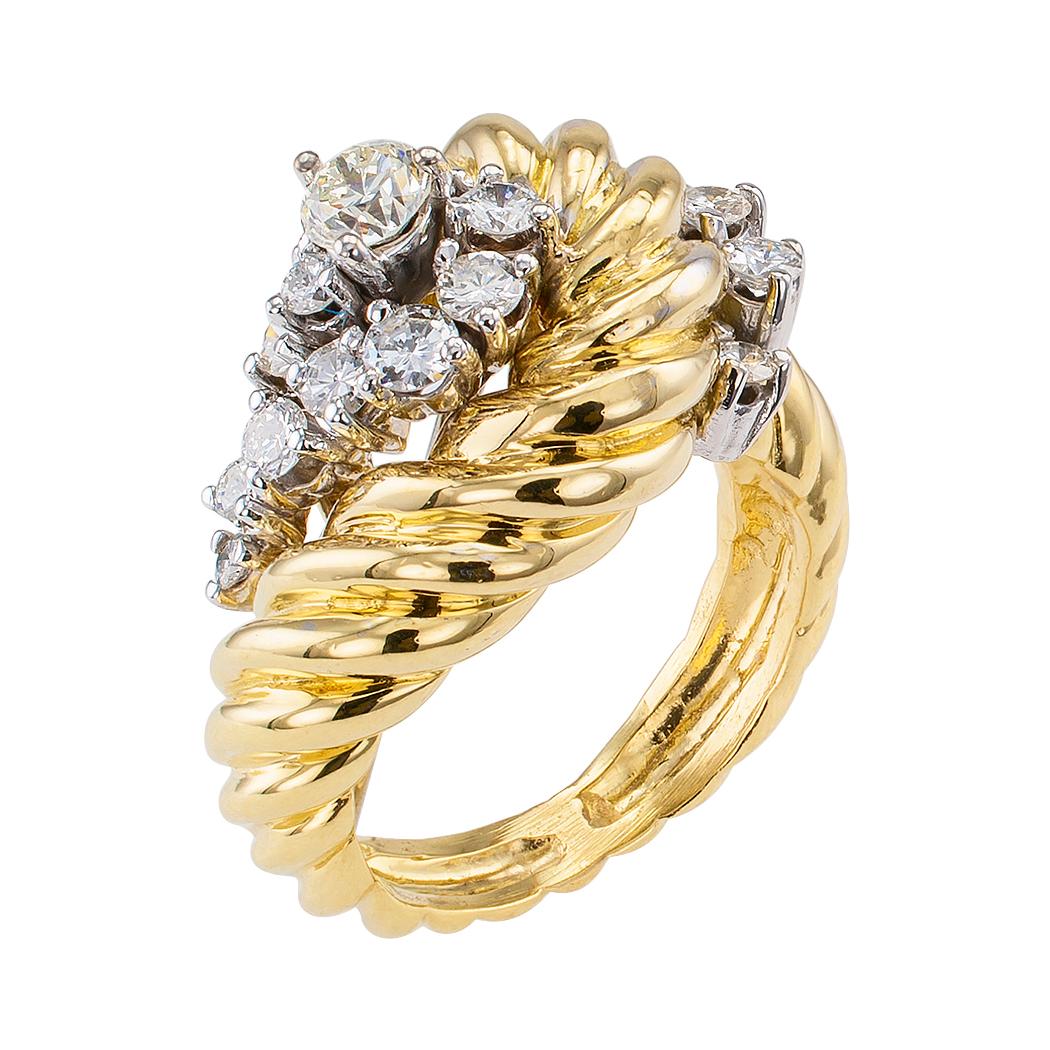 Diamond and yellow gold lady’s cluster ring circa 1970.

DETAILS:  Estate diamond and yellow gold cluster ring.
Seventeen round brilliant-cut diamonds set in 18 karat white gold totaling approximately 1.00 carat, approximately H – K color and VS –