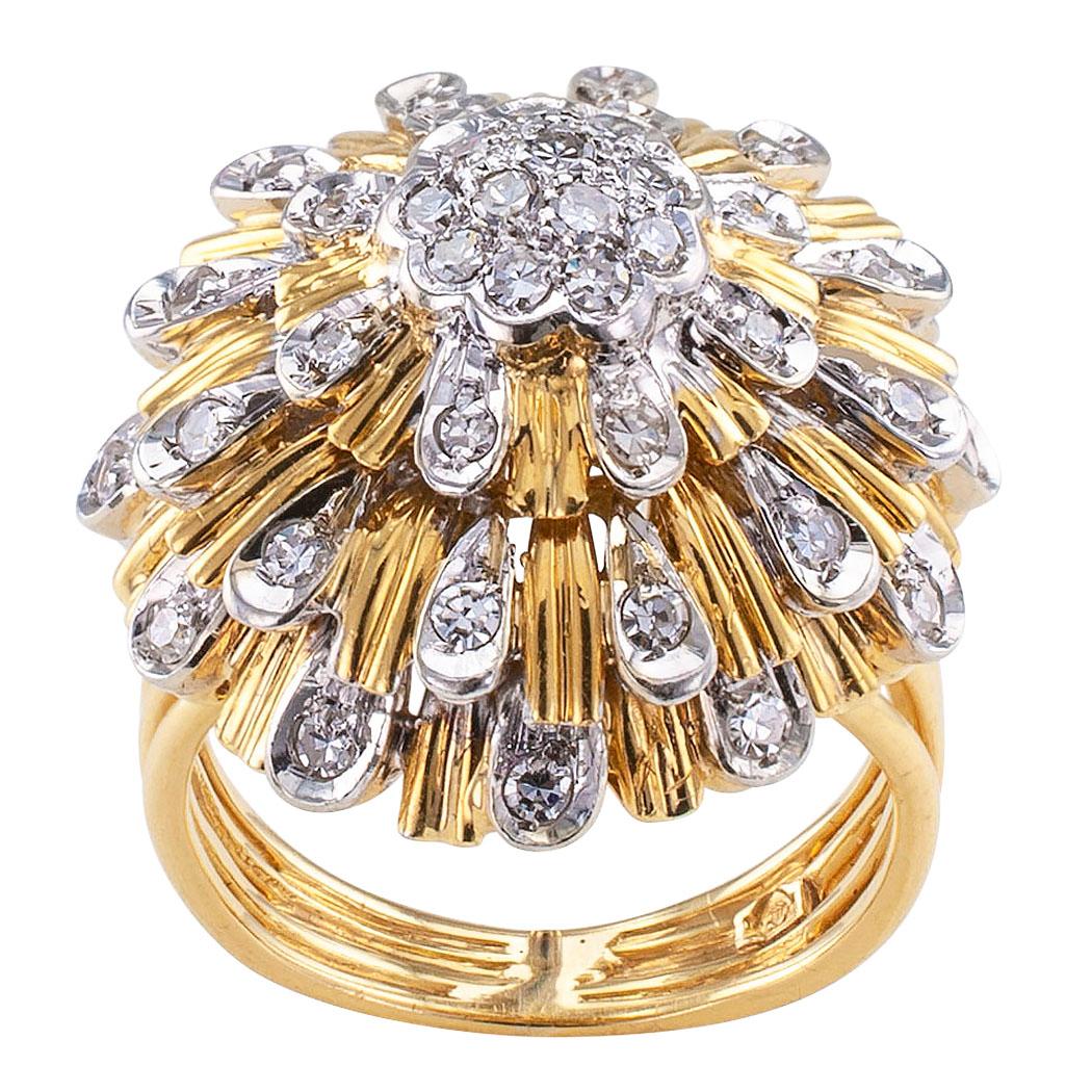 Diamond and two-tone gold cocktail ring circa 1970. Designed to look like an umbrella dripping with raindrops, the circular ring centers upon a cluster of diamonds framed by a radiating, triple stepped border comprising fluted gold motifs