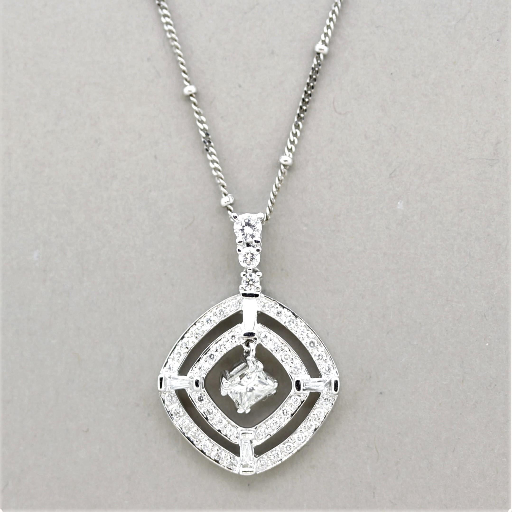 A fun and stylish diamond pendant! It features a large single princess-cut diamond weighing 0.42 carats and is drop-set in the middle of the pendant. It is accented by two outer rows of round brilliant-cut and baguette-cut diamonds which weigh a