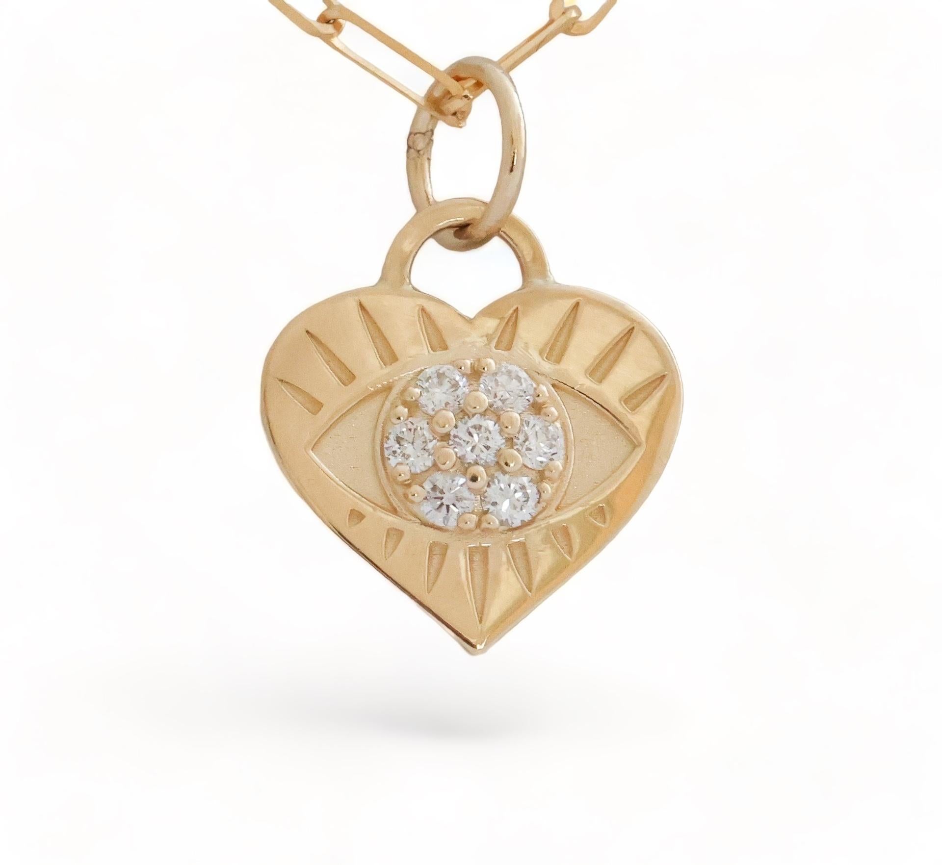 Looking for love in all the right places. The Eye Love pendant symbolize the heart that sees all. A beautiful reminder to see with our true essence of love. 
Set in 14 karat yellow gold, the Eye Love pendant features seven round diamonds that weigh