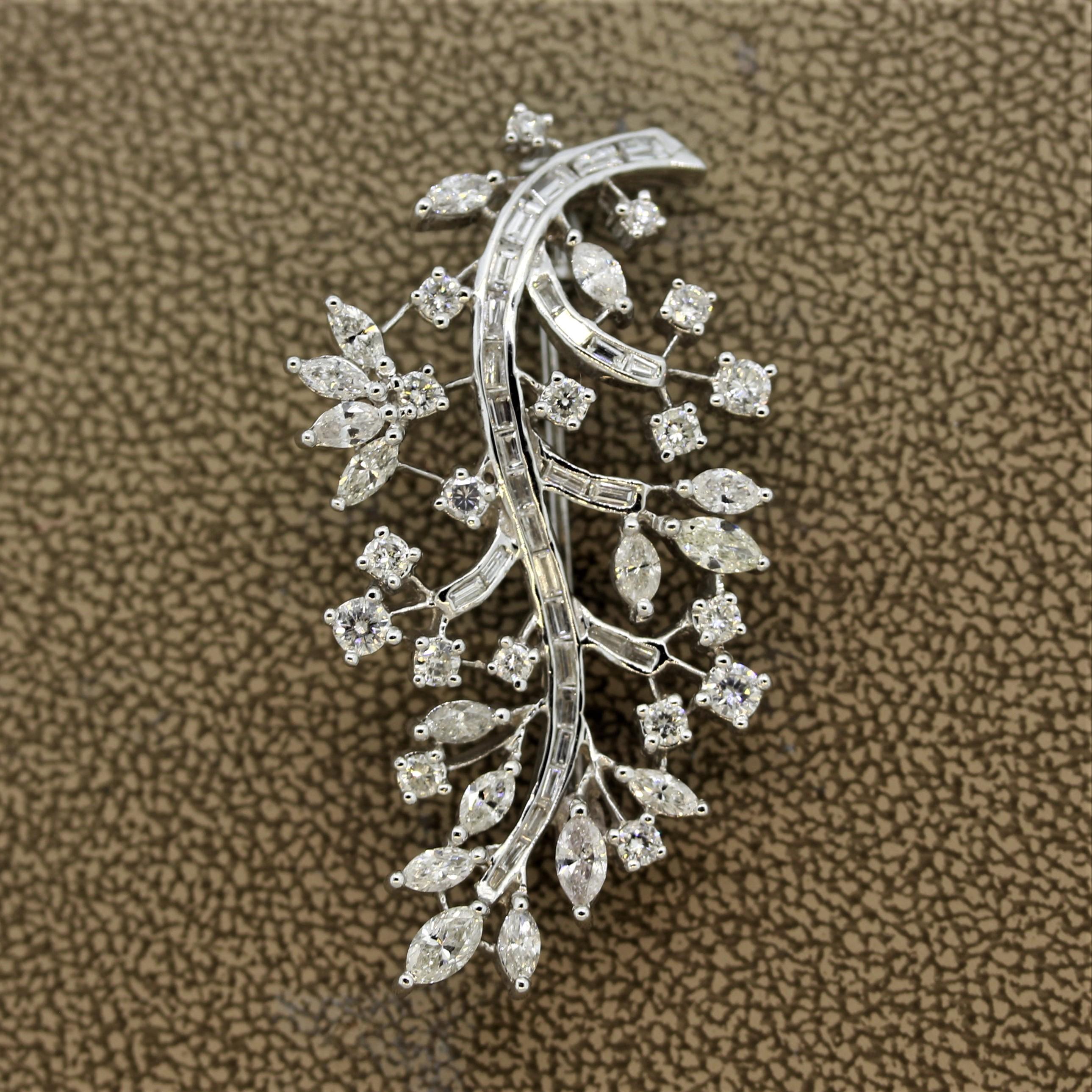 A spray brooch featuring 4.48 carats of round, baguette and marquise shaped diamonds. They are arranged in a floral pattern depicting growth. Made in 18k white gold and ready to be worn with any outfit.

Length: 1.7 inches
