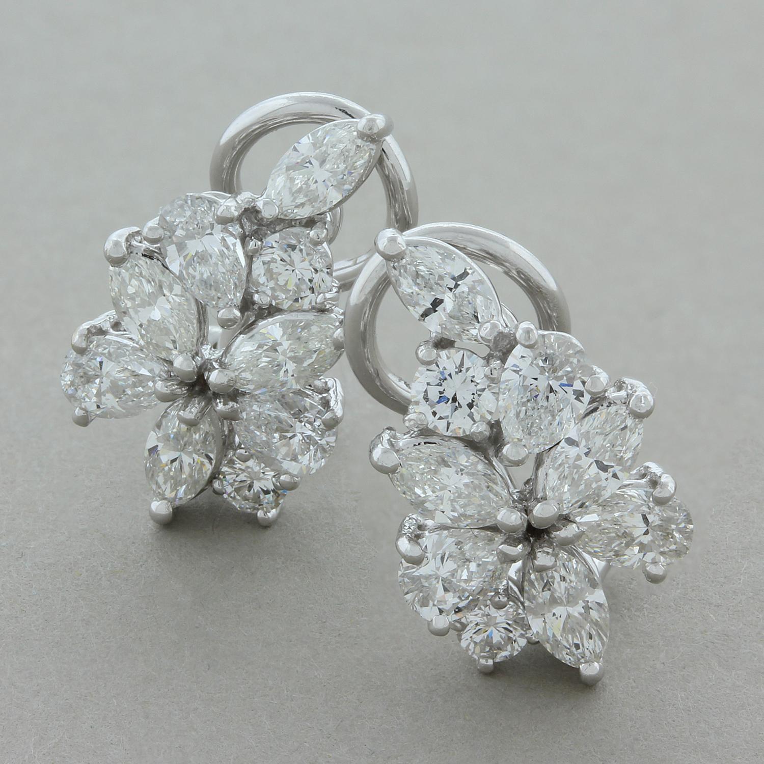 These cute flower cluster earrings feature 3.40 carats of diamonds, marquise, pear and round brilliant cut. The cluster is set in 18K white gold with an omega backing. 

Earring Length: 0.50 inches
Earring Width: 0.25 inches
