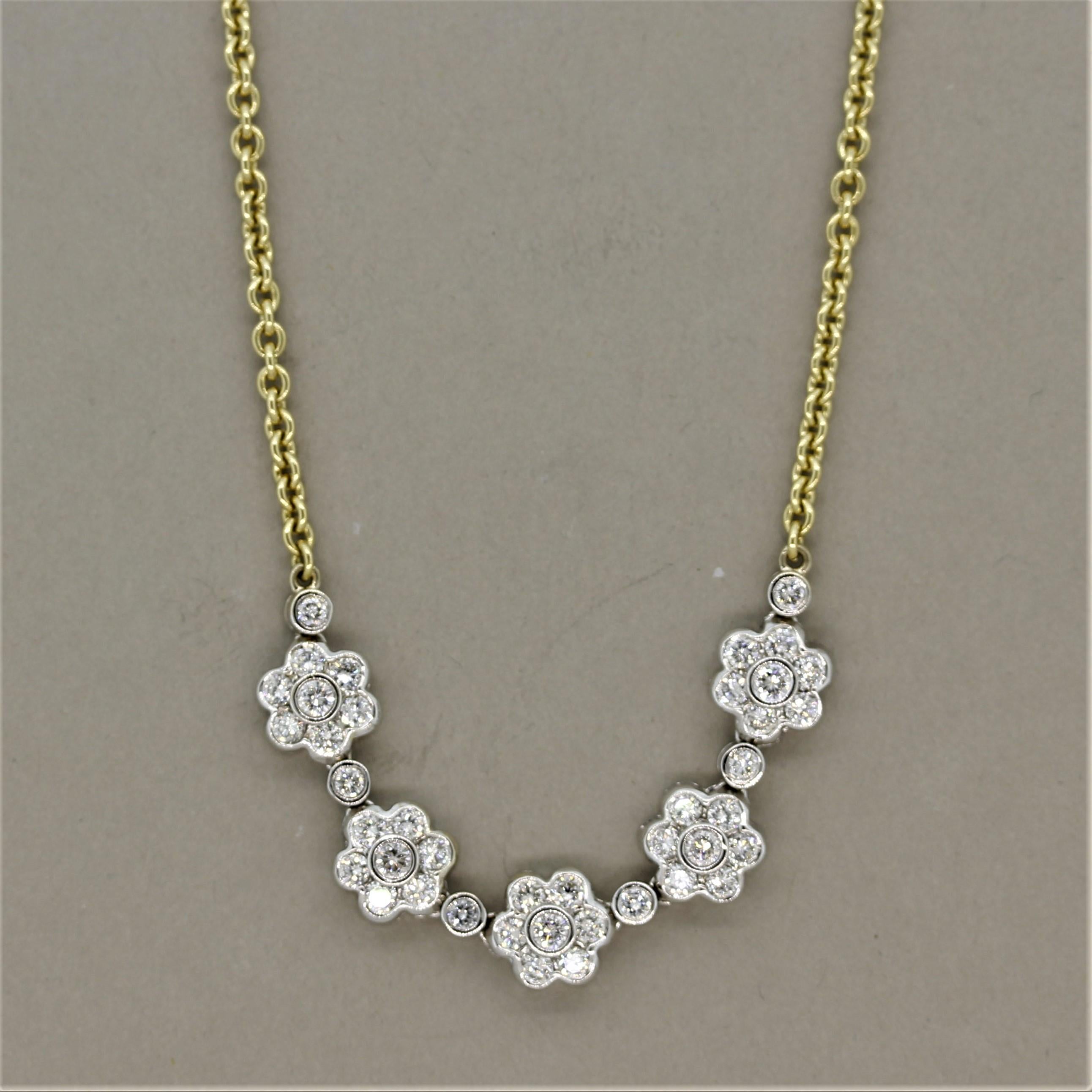 A sweet and stylish necklace made in 18k gold. It features 1.39 carats of round brilliant cut diamonds which are bezel set in a floral pattern creating 5 flowers. The flowers are made in white gold while the rest of the necklace is made in yellow