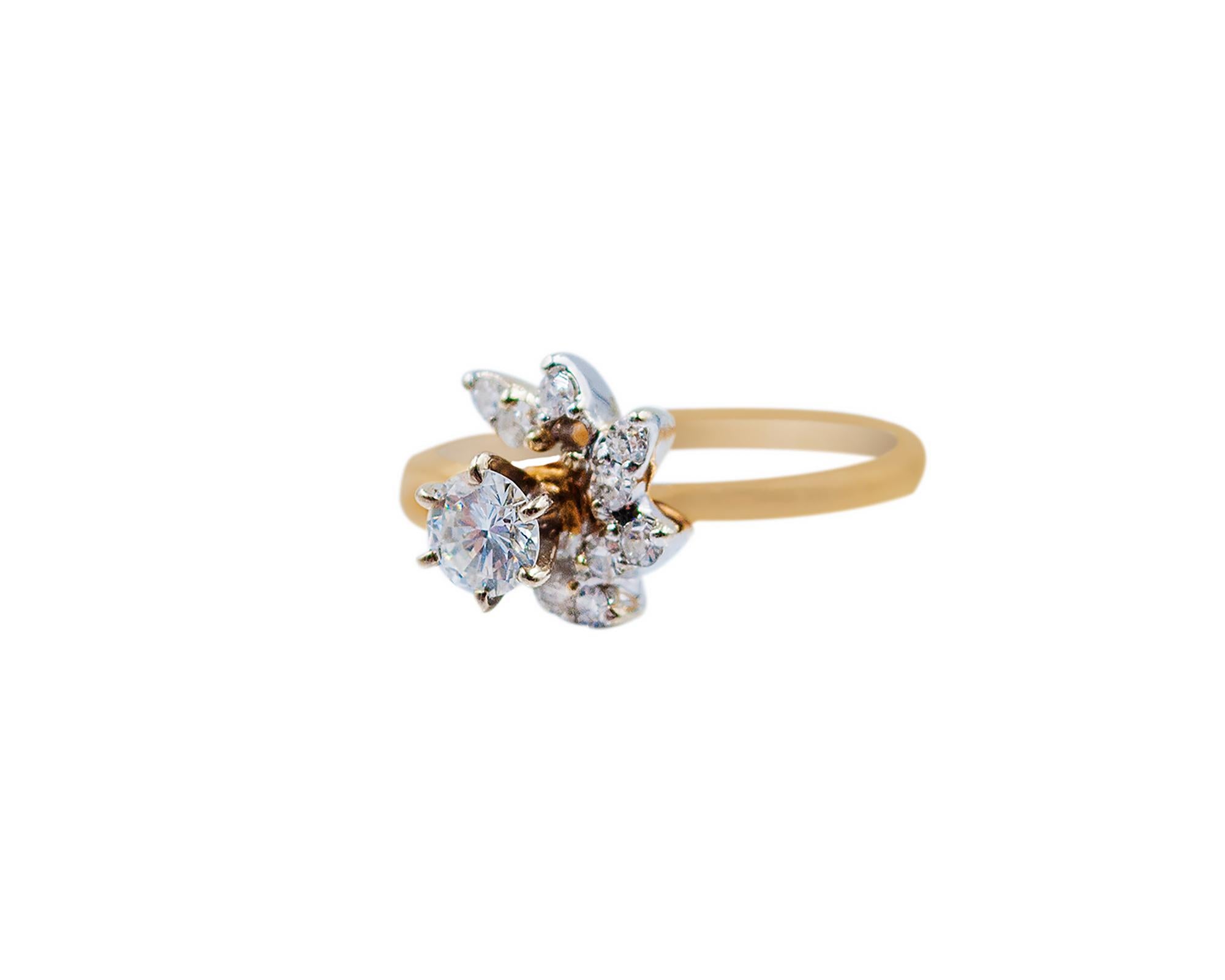 A lovely ring designed as a flower, embellished with diamonds and made in 14K yellow gold.
Center diamond is 0.40 carat round, G color.
10 round diamonds around with the total weight of 0.08 carats.
Size 5.5.