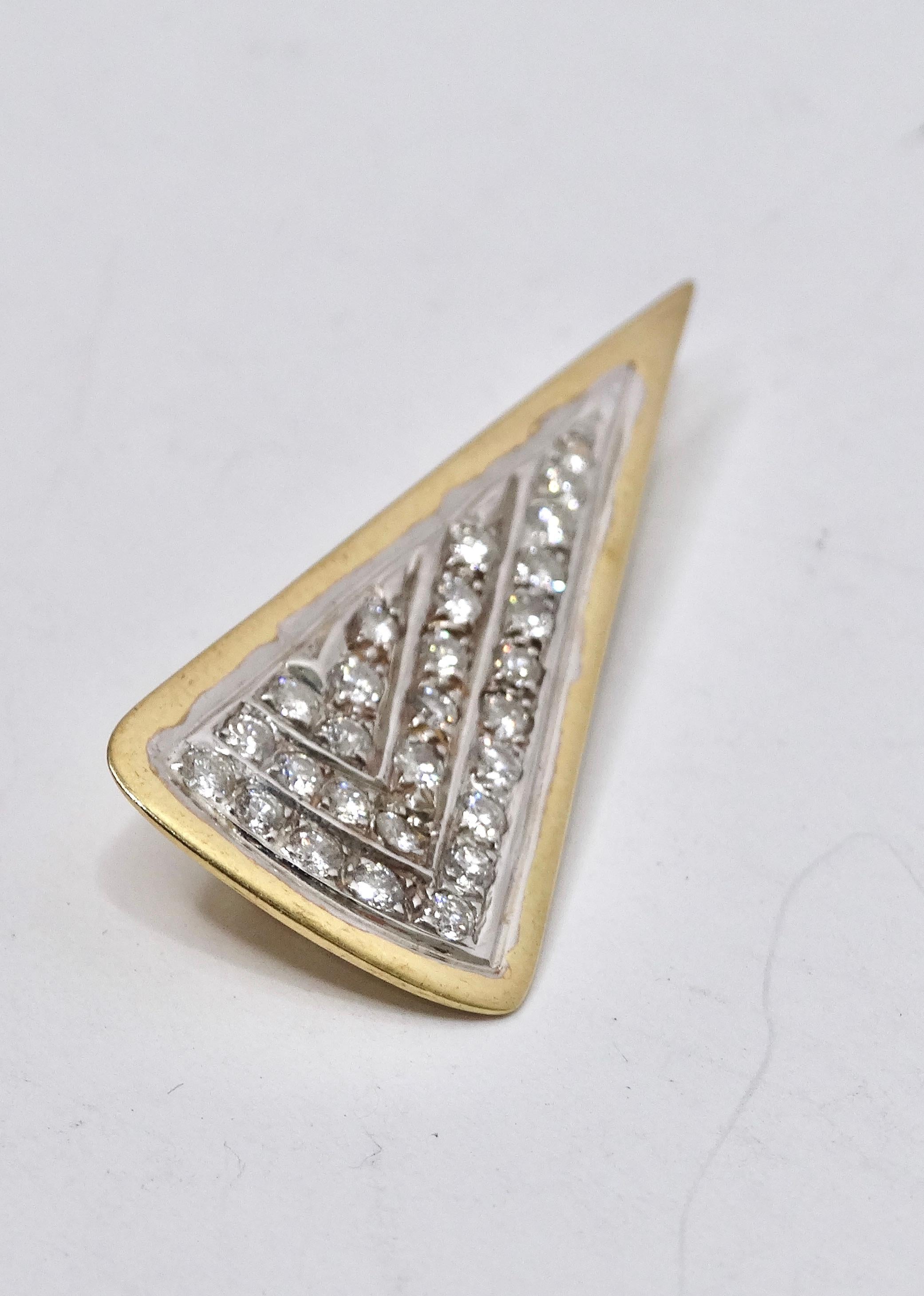 This brooch is a tiny accessory that can pack a big punch. This brooch is an Art Deco gem! The sparkle of the diamonds will catch someone from across the room. It features a vibrant gold piping with 28 round diamonds adorning the middle. It is made