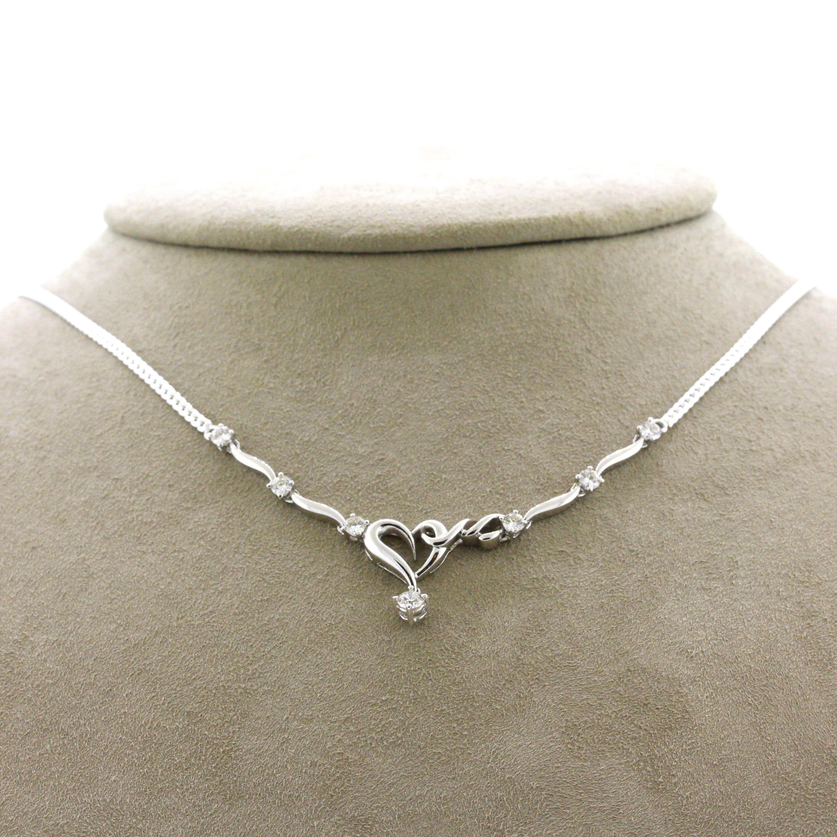 A simple and stylish necklace designed in a heart motif style! It features 7 round brilliant-cut diamonds weighing a total of 0.72 carats. The necklace is made in 18k white gold with a braided chain.

Length: 19 inches

Weight: 11.4 grams