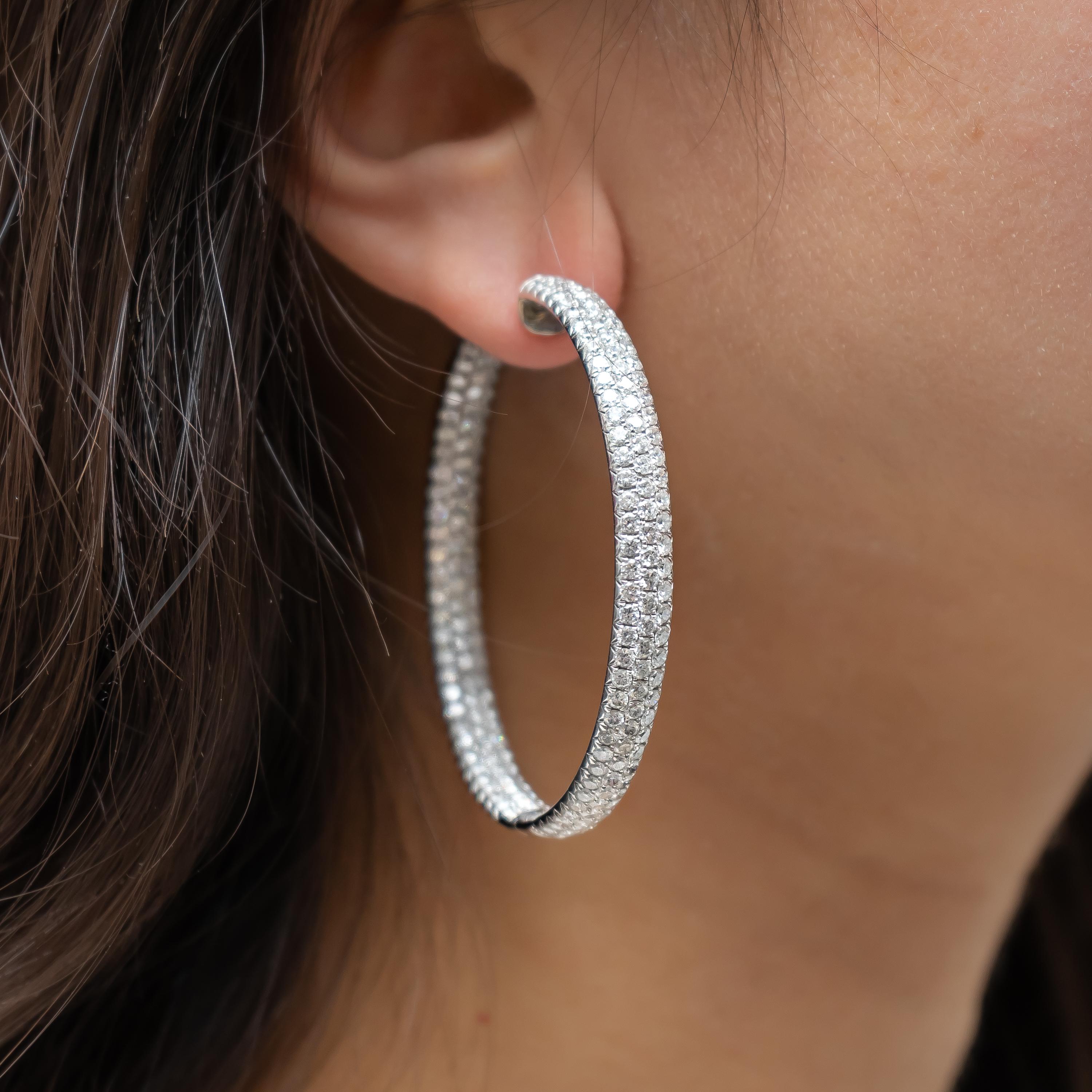 A pair of diamond hoop earrings, set with round brilliant cut diamonds in a pave setting. Mounted in 18ct white gold. Estimated total diamond weight 14.00ct