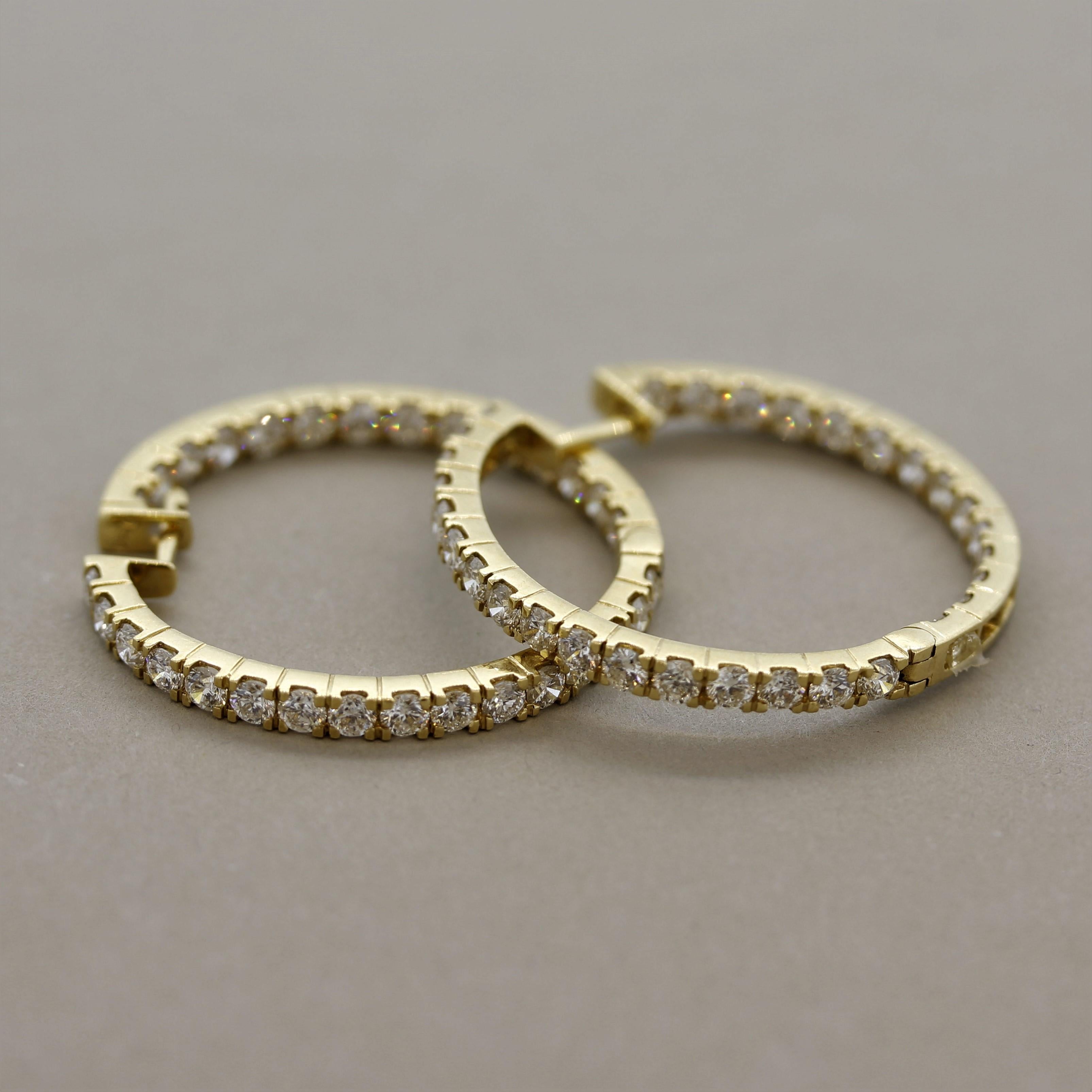 A lovely pair of hoop earrings featuring 4.22 carats of round brilliant cut diamonds. They are set both inside and outside of the earrings making it appear as if the entire earring is covered in diamonds! Made in 18k yellow gold.

Length: 1.1 inches