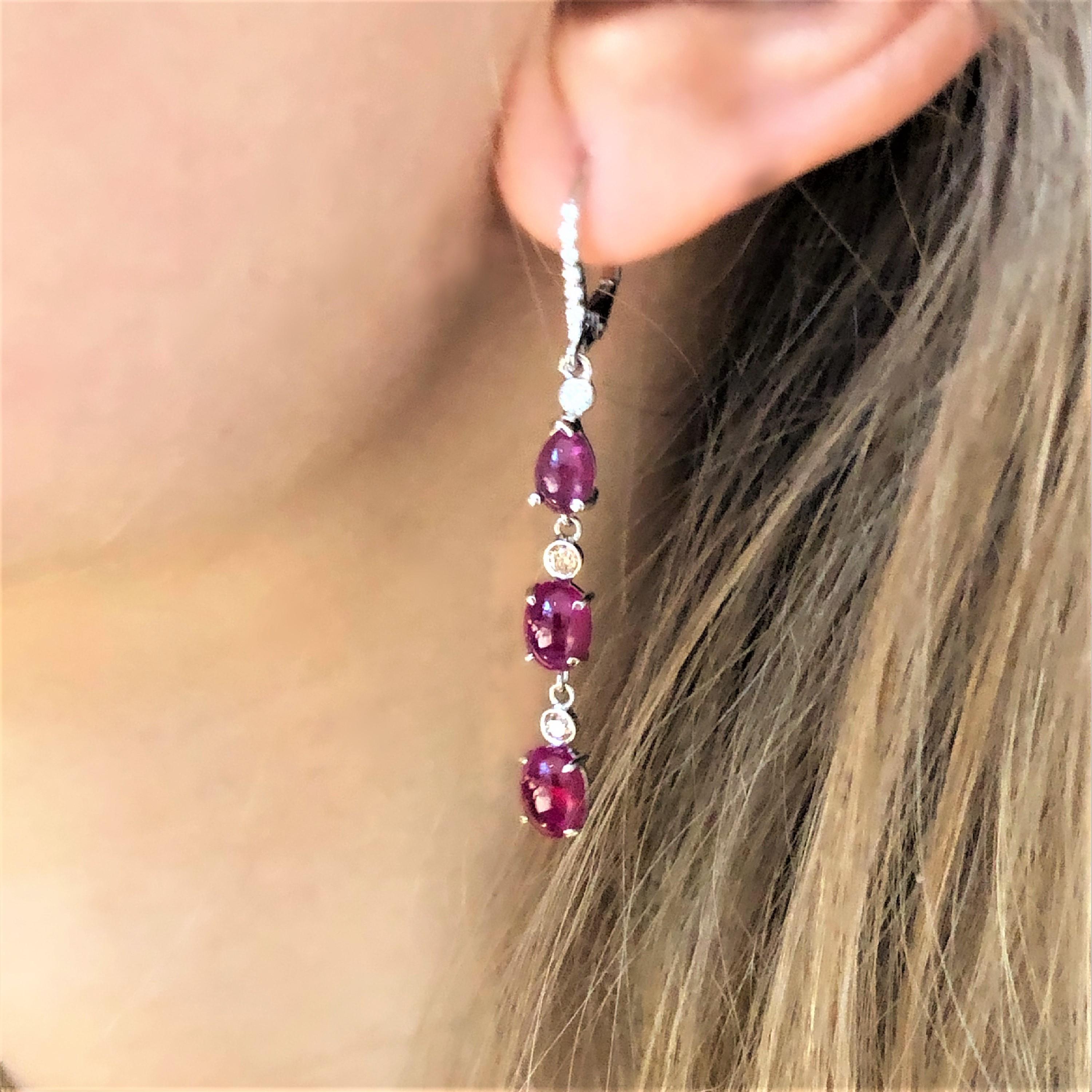 Fourteen karats white gold hoop drop earrings two-inch long
White diamonds weighing 0.30 carat 
Pear shape and oval shape Burma cabochon rubies weighing 7.85 carat
Four Champagne diamonds weighing 0.12 carat
One of a kind earring
New