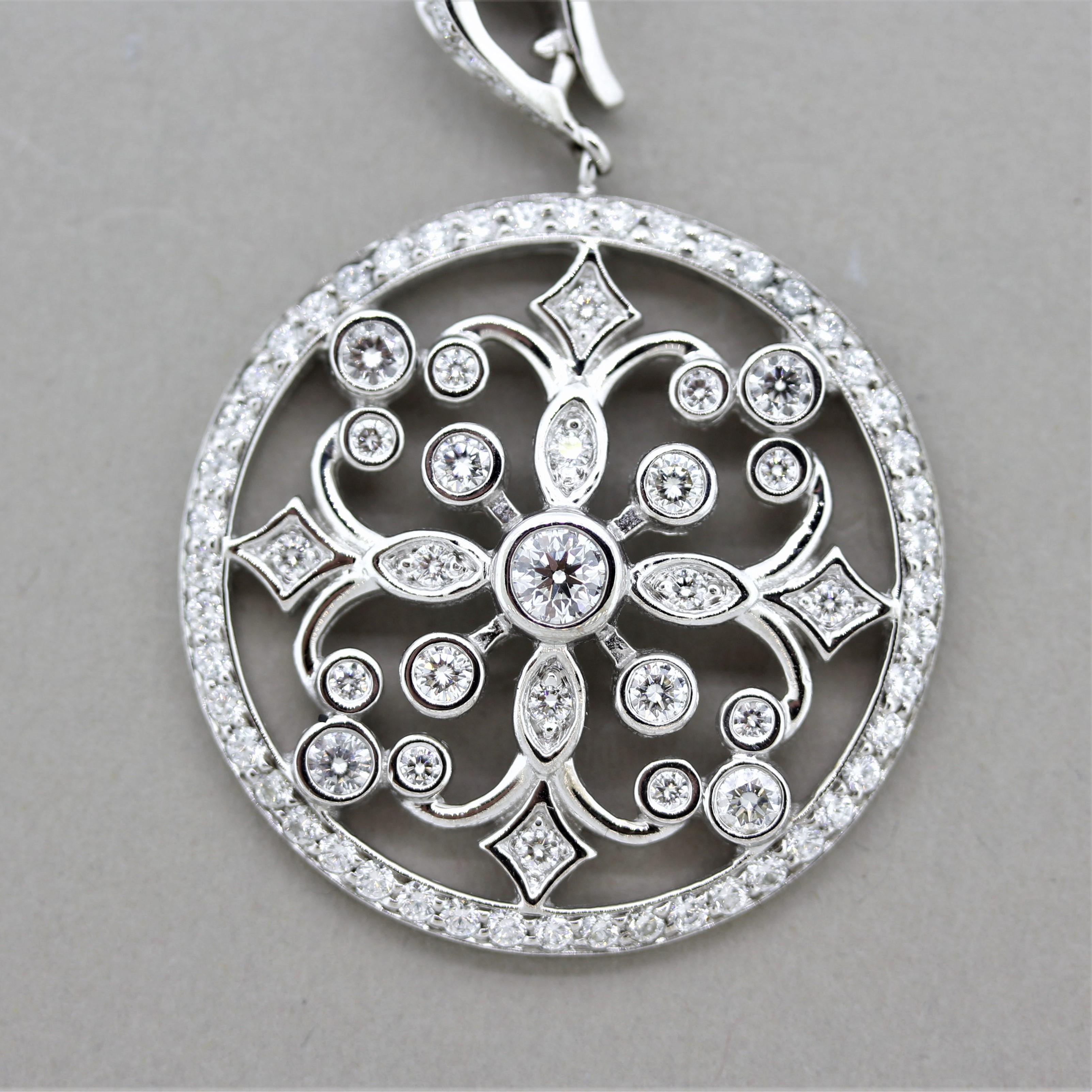 A lovely diamond pendant made in 18k white gold. It features a total of 2.16 carats of round brilliant-cut diamonds set around the pendant in stylish patterns. There are smaller rounds set on the border of the medallion while larger stones are set