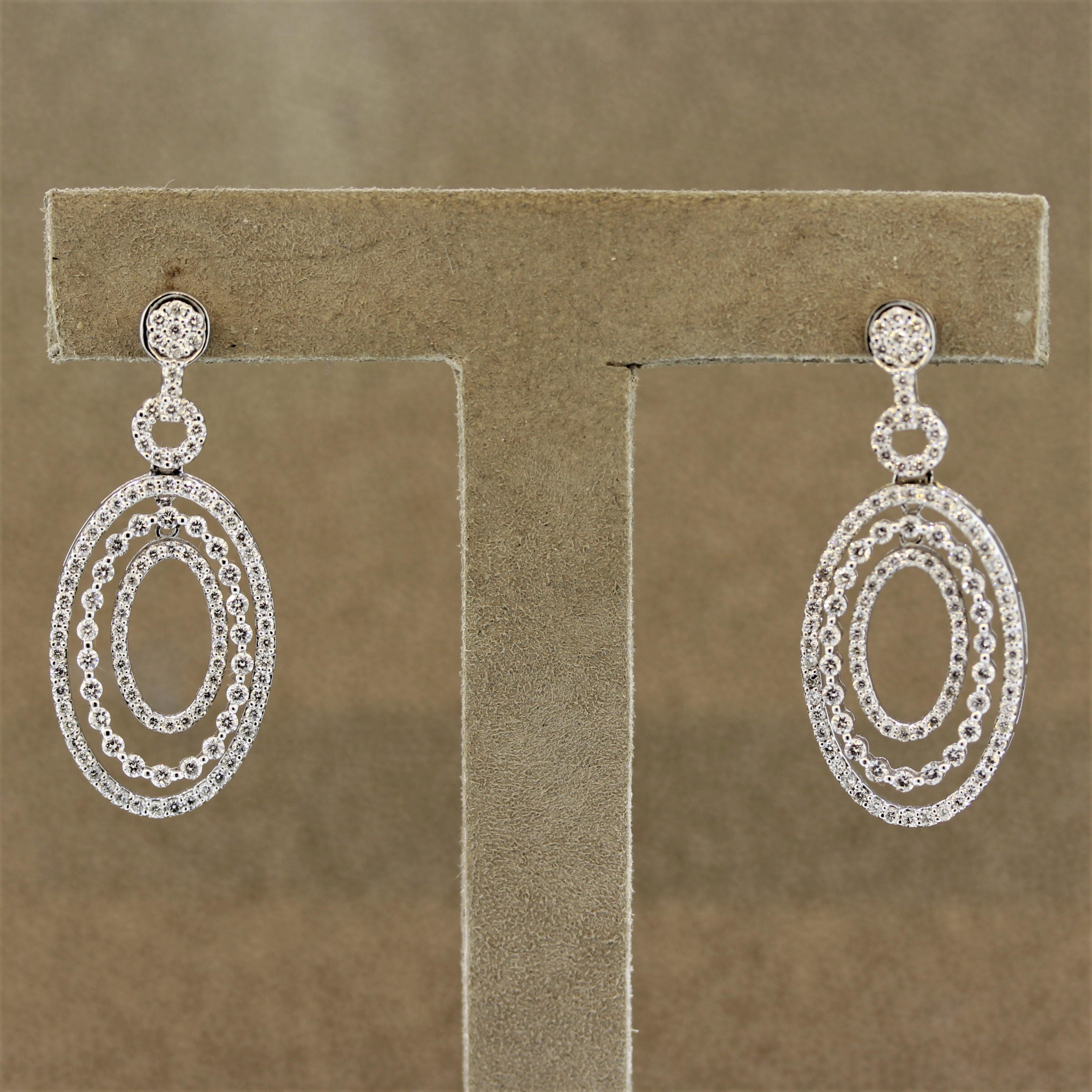 A stylish and fabulous pair of earrings featuring 2.12 carats of round brilliant cut diamonds. They are set along the entirety of the earrings as well as the 3 hoops which are all independent of each other with their own drop and movement. Made in