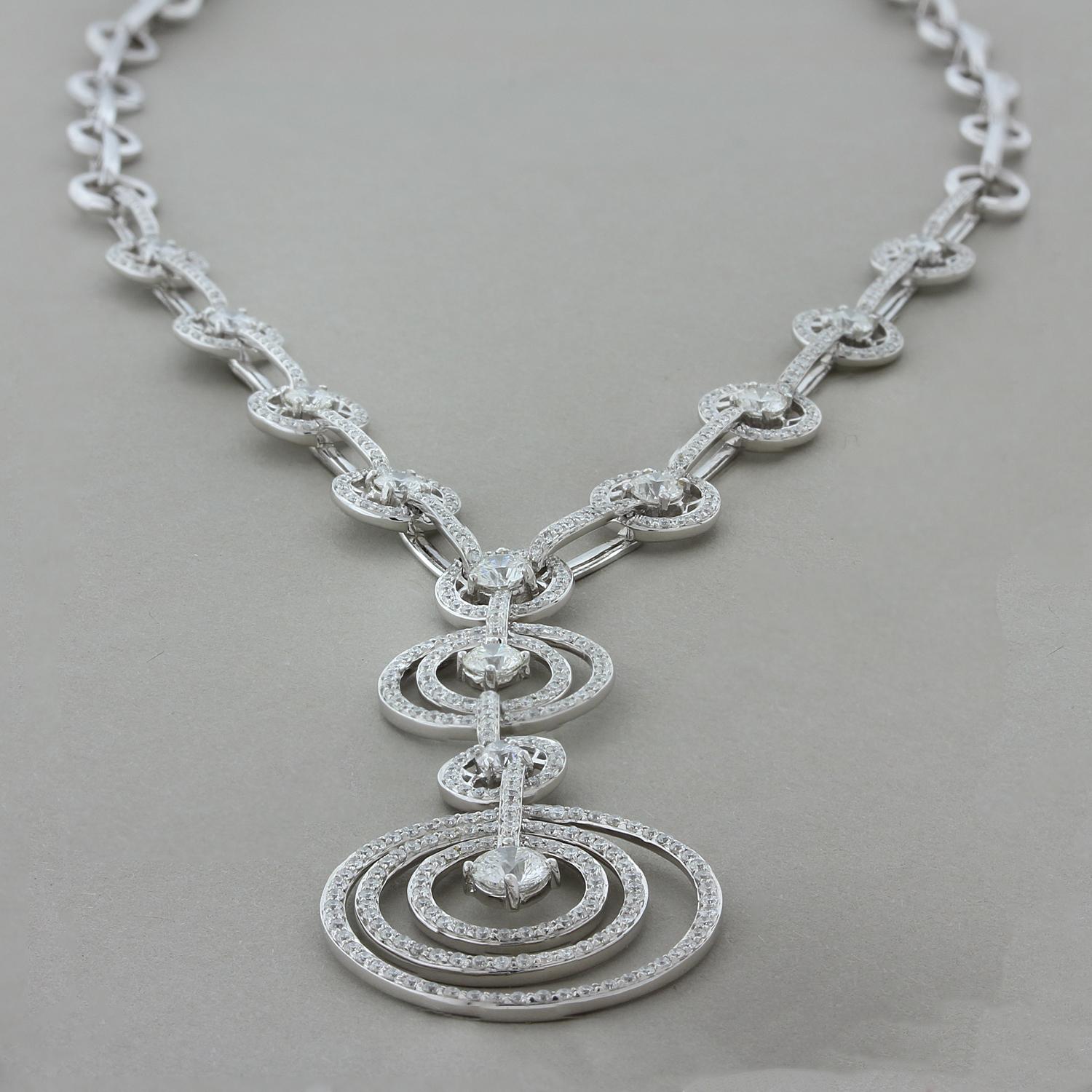 A spectacular necklace featuring 5.01 carats of round brilliant cut diamonds. The necklace drop has sets of halos which move independently of each other giving the piece movement. Set in 18K white gold with a box clasp closure and two safety