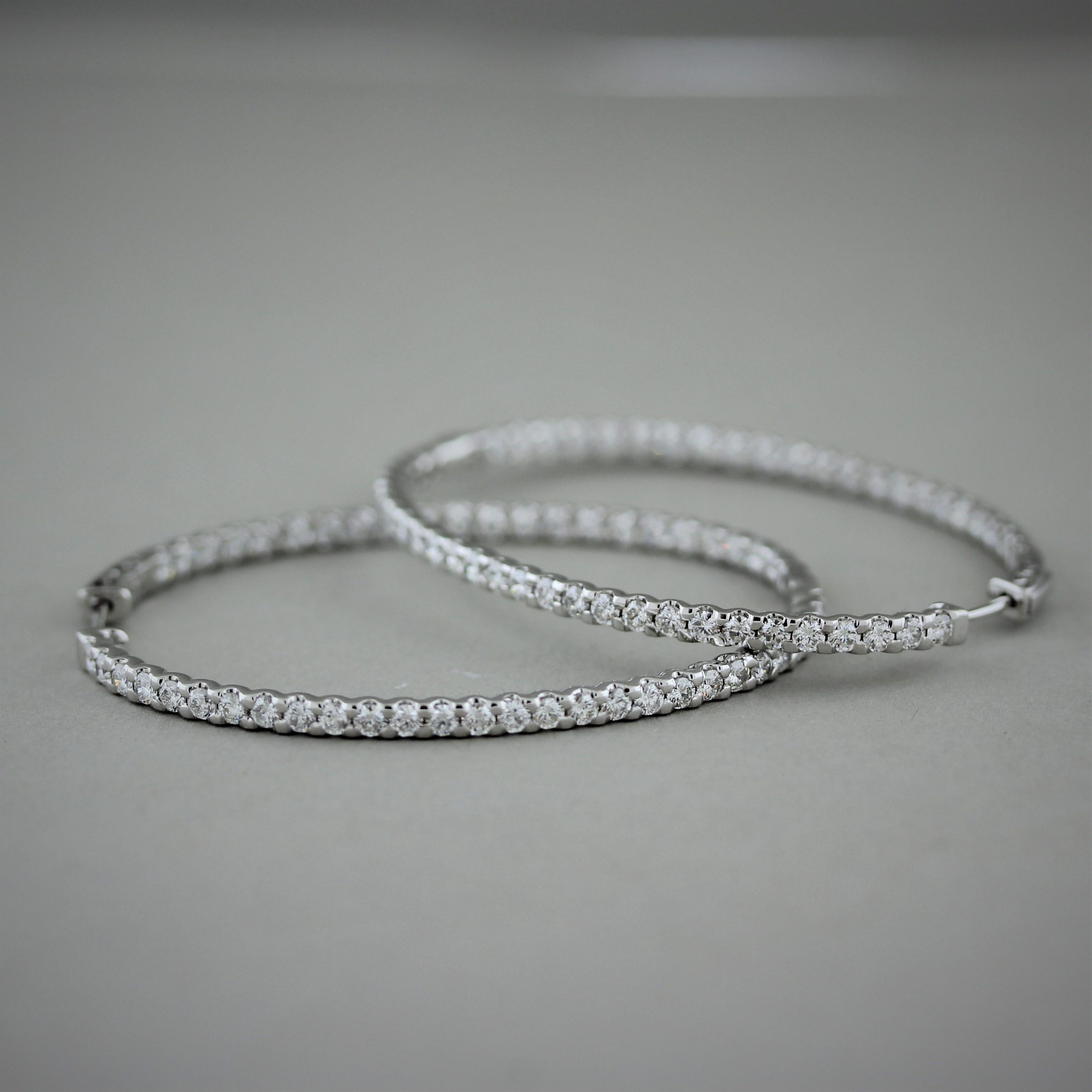 A long pair of hoop earrings in an oval shape. They feature 4.24 carats of round brilliant cut diamonds set in 14k whtie gold. A simple yet elegant pair of earrings that can be worn everyday.


Length: 1.95 inches


Width: 1.5 inches
