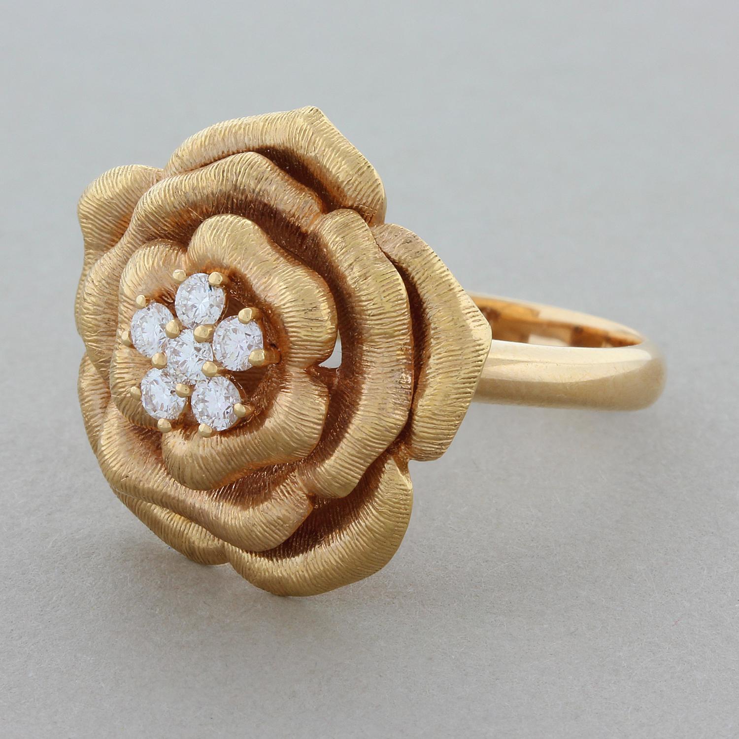 This lovely modern designed rose ring featured a center of 6 cluster set round brilliant cut diamonds totaling 0.34 carats. The 18K rose gold pedals of the flower are all brush finished giving the piece a textured and lively look.

Ring Size 7